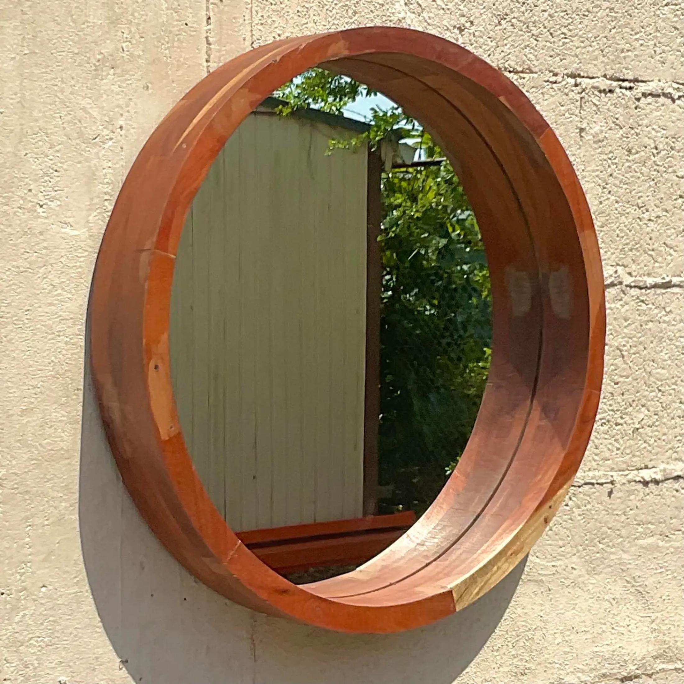 A fabulous vintage Boho round wooden mirror. Beautiful wood grain detail in a clean contemporary design. Acquired from a Palm Beach estate