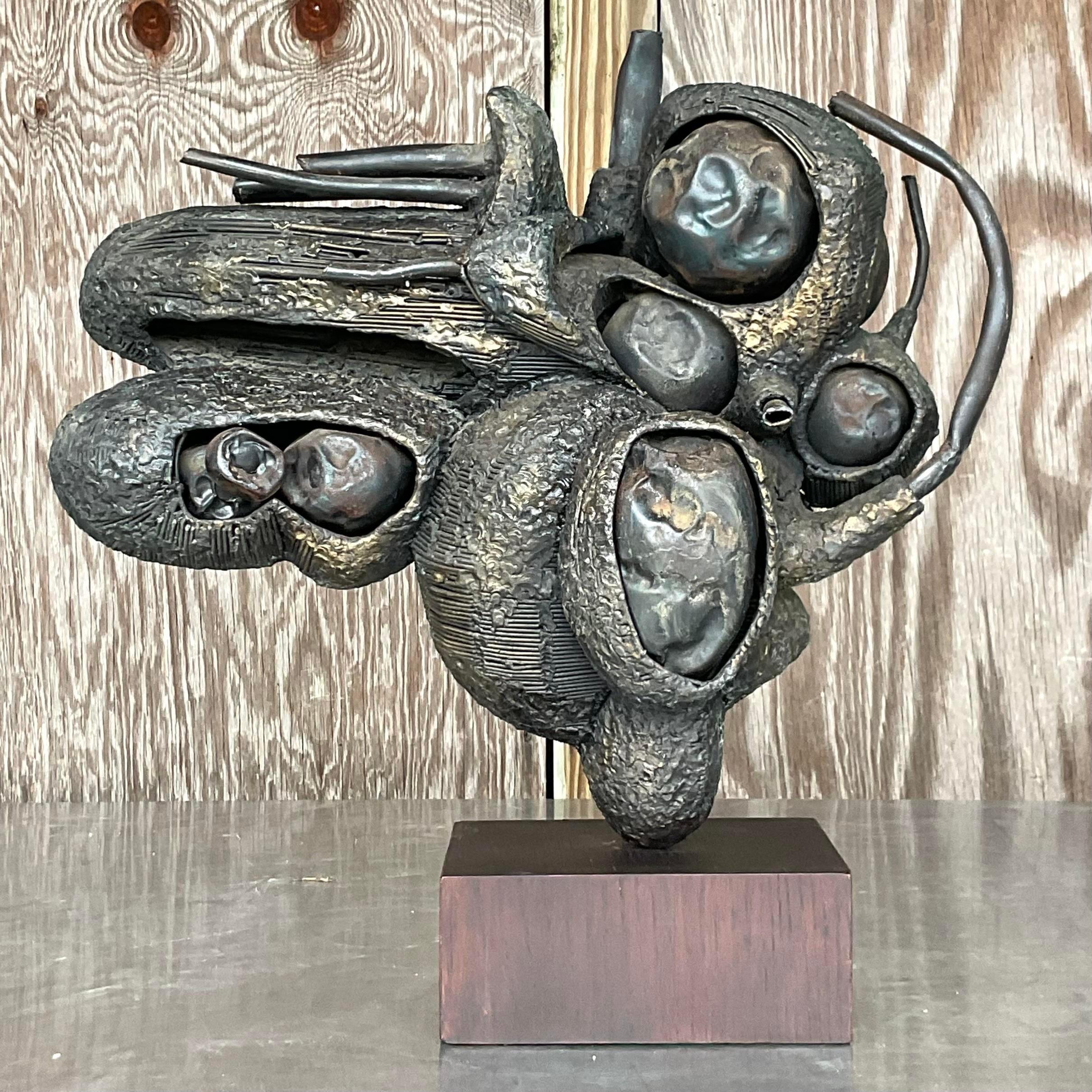 A fabulous vintage Boho sculpture. Made by the artist Rudolph Seno. A chic bronze abstract composition with a beautiful patina from time. Rests on a black wood plinth. Acquired from a Palm Beach estate.