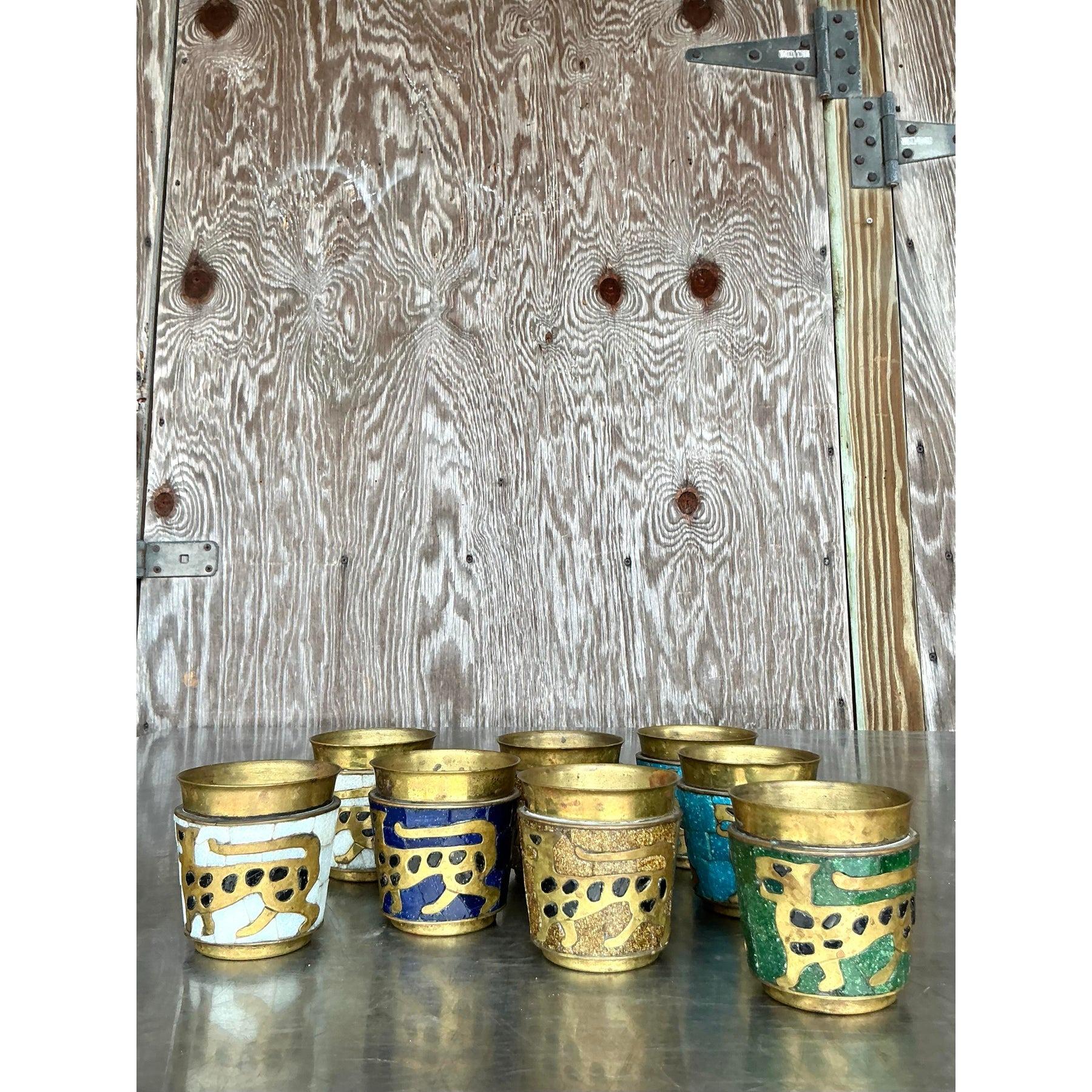This exquisite set of eight vintage mosaic rocks glasses showcases an intricate handcrafted design, embodying the essence of bohemian and Persian-inspired artistry. Each glass features a striking golden jaguar motif set against a mosaic backdrop in