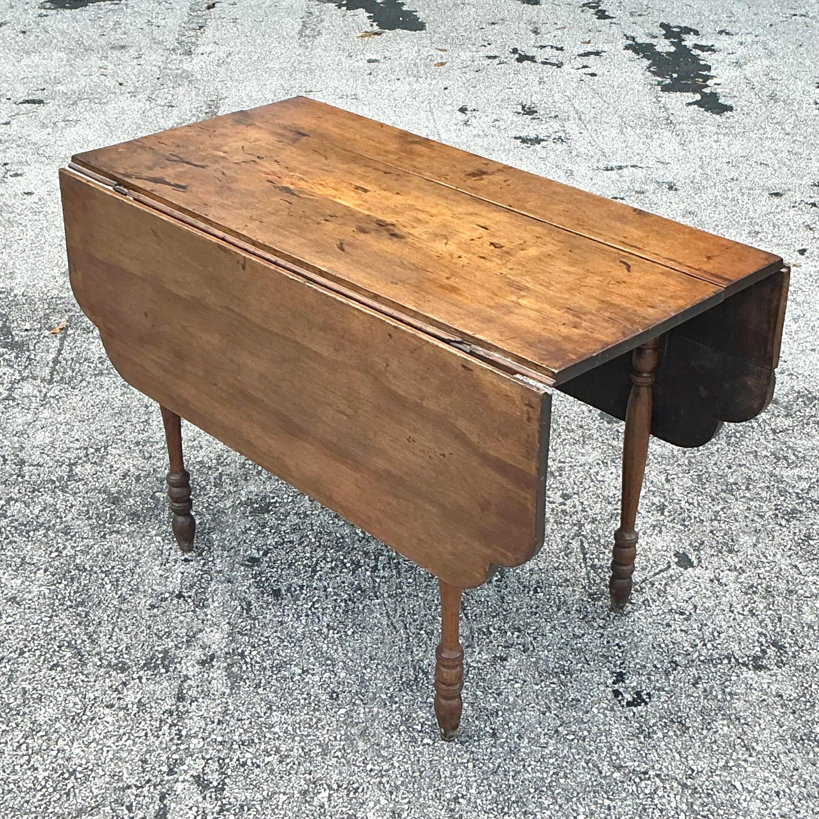 The Vintage Boho Scalloped Plank Drop Leaf Table offers a perfect blend of bohemian charm and rustic functionality. With its scalloped edges and versatile drop leaf design, this table adds a unique touch to your decor while providing flexible space