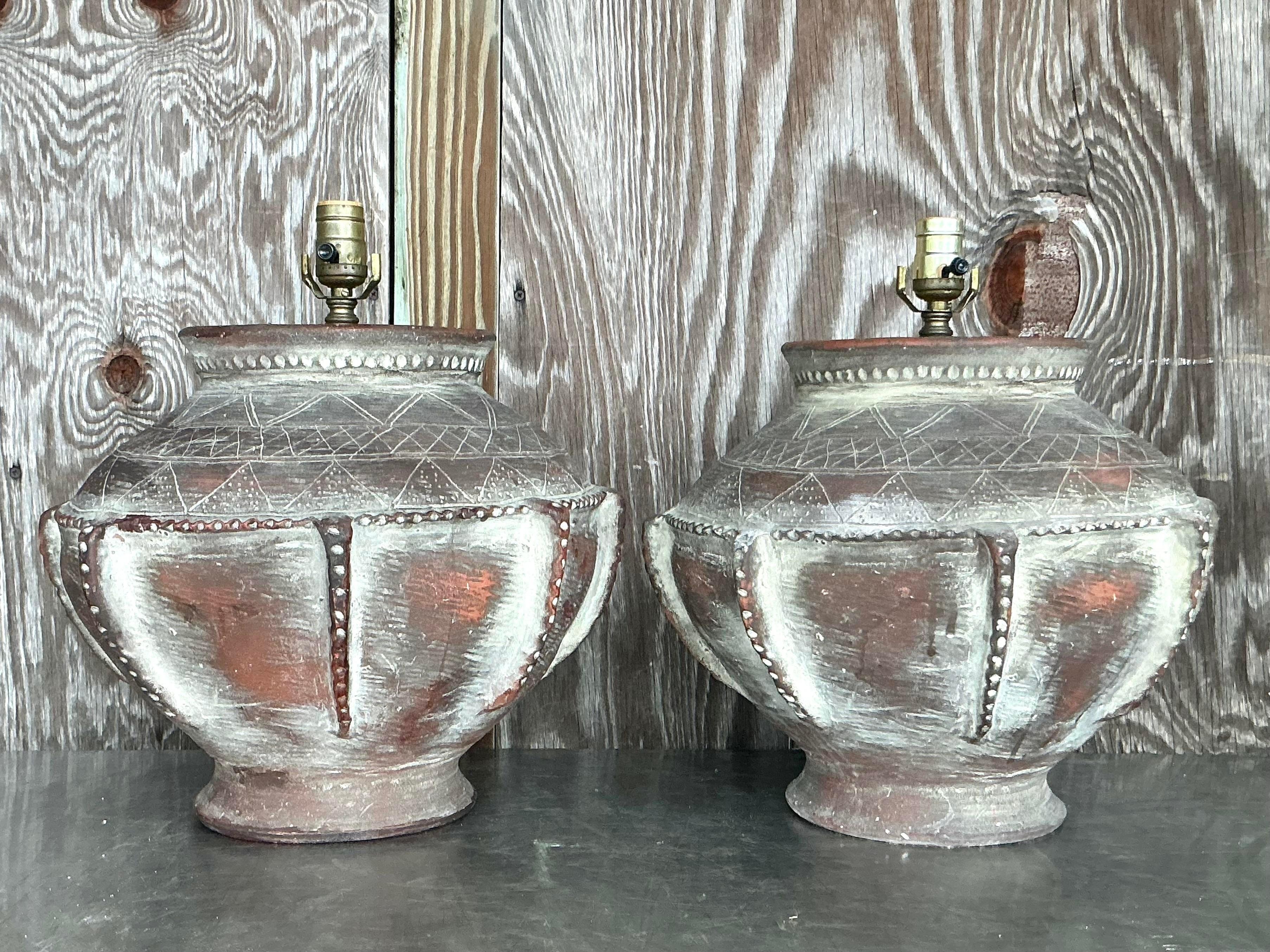 Ajoutez une élégance terreuse à votre espace avec cette paire de lampes Vintage Boho Scored en terre cuite. Ces lampes présentent une finition en terre cuite sculptée à la main avec des détails de rainurage complexes, ce qui leur confère un aspect