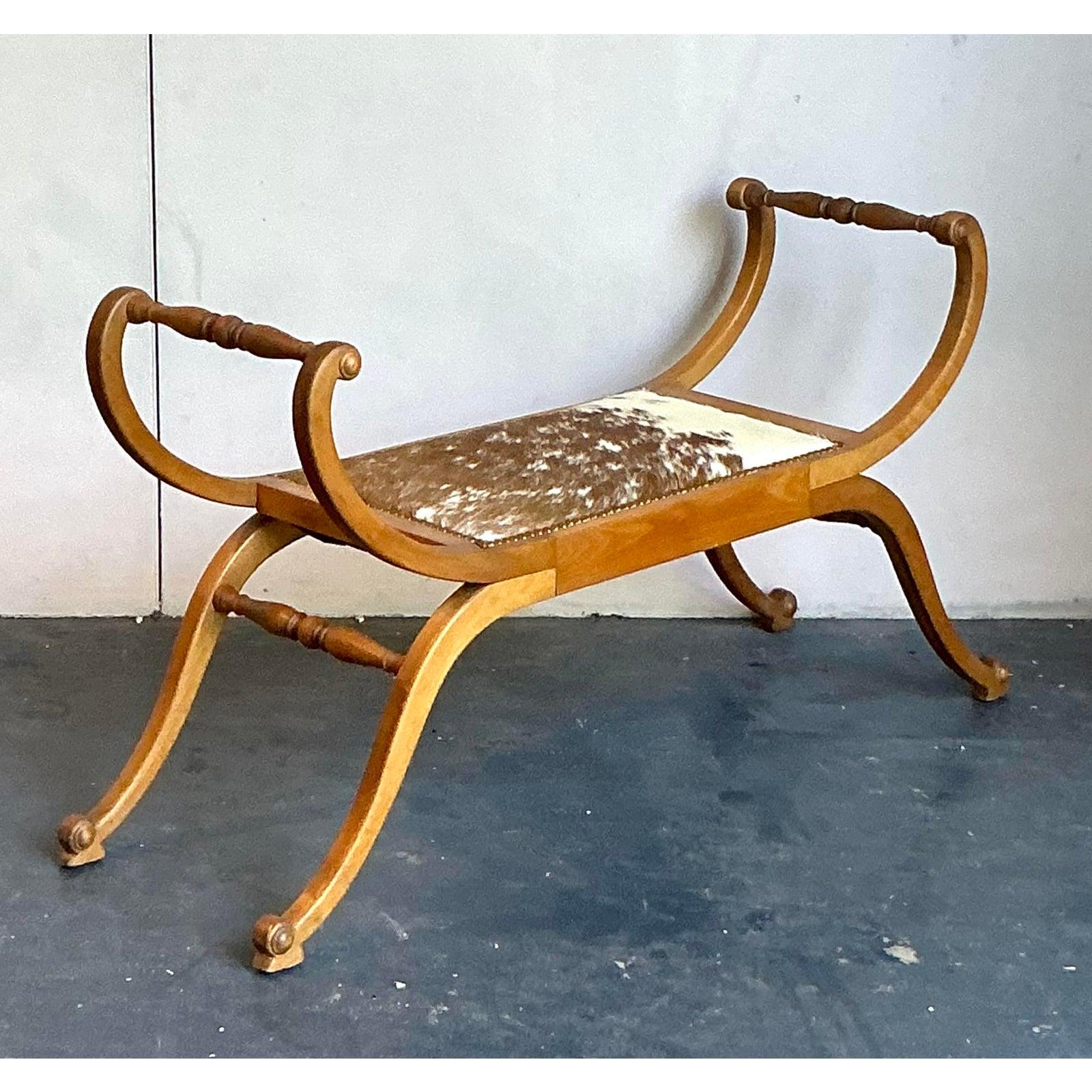 Make a bold and sophisticated statement with this exceptional vintage curule bench. Inspired by the classic Roman 'sella curulis,' this piece features a gracefully sculpted solid wood frame with elegant, intersecting scroll legs and distinctive