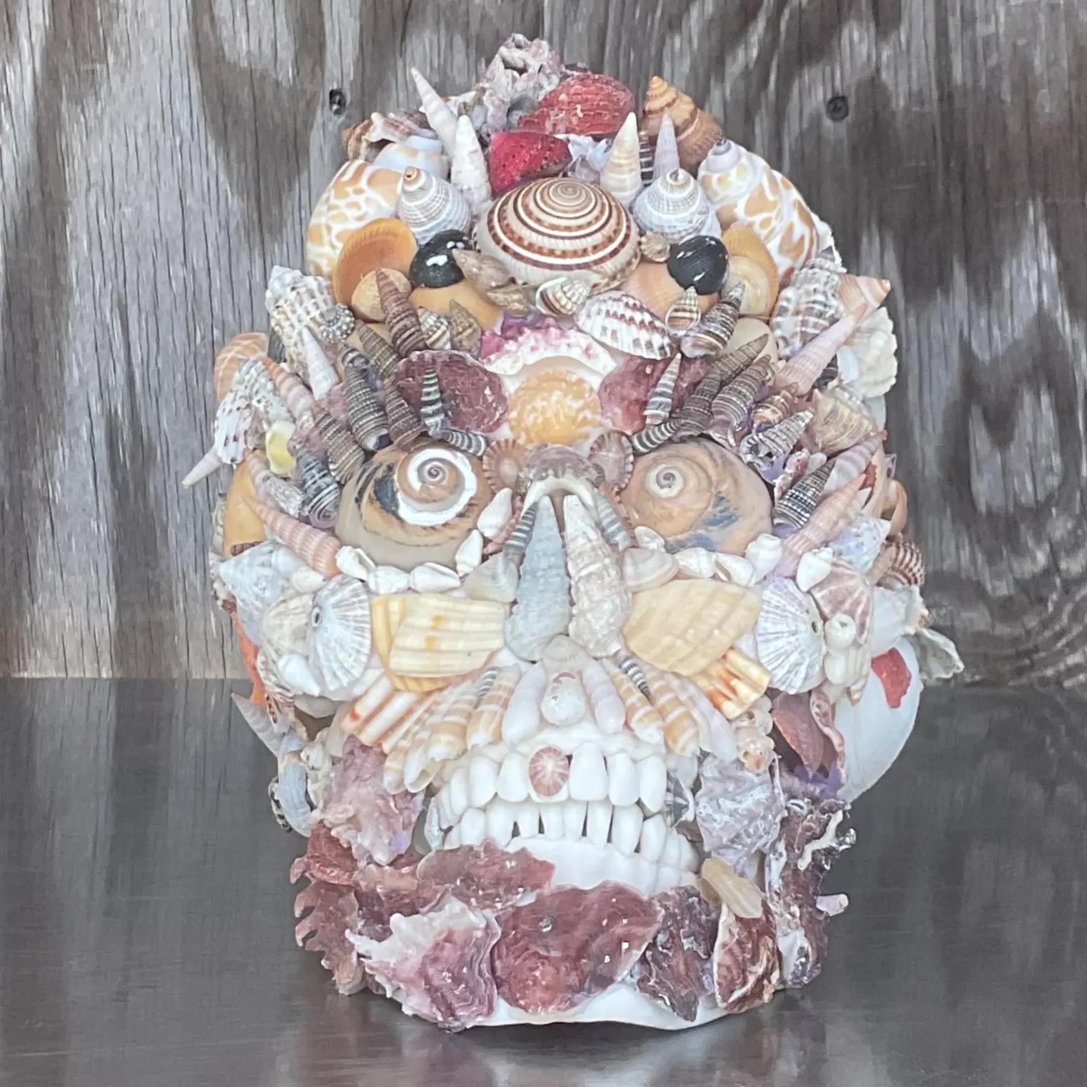An fantastic vintage Boho skull. A chic shell encrusted composition. Signed by the artist on the bottom. Acquired from a Palm Beach estate. 