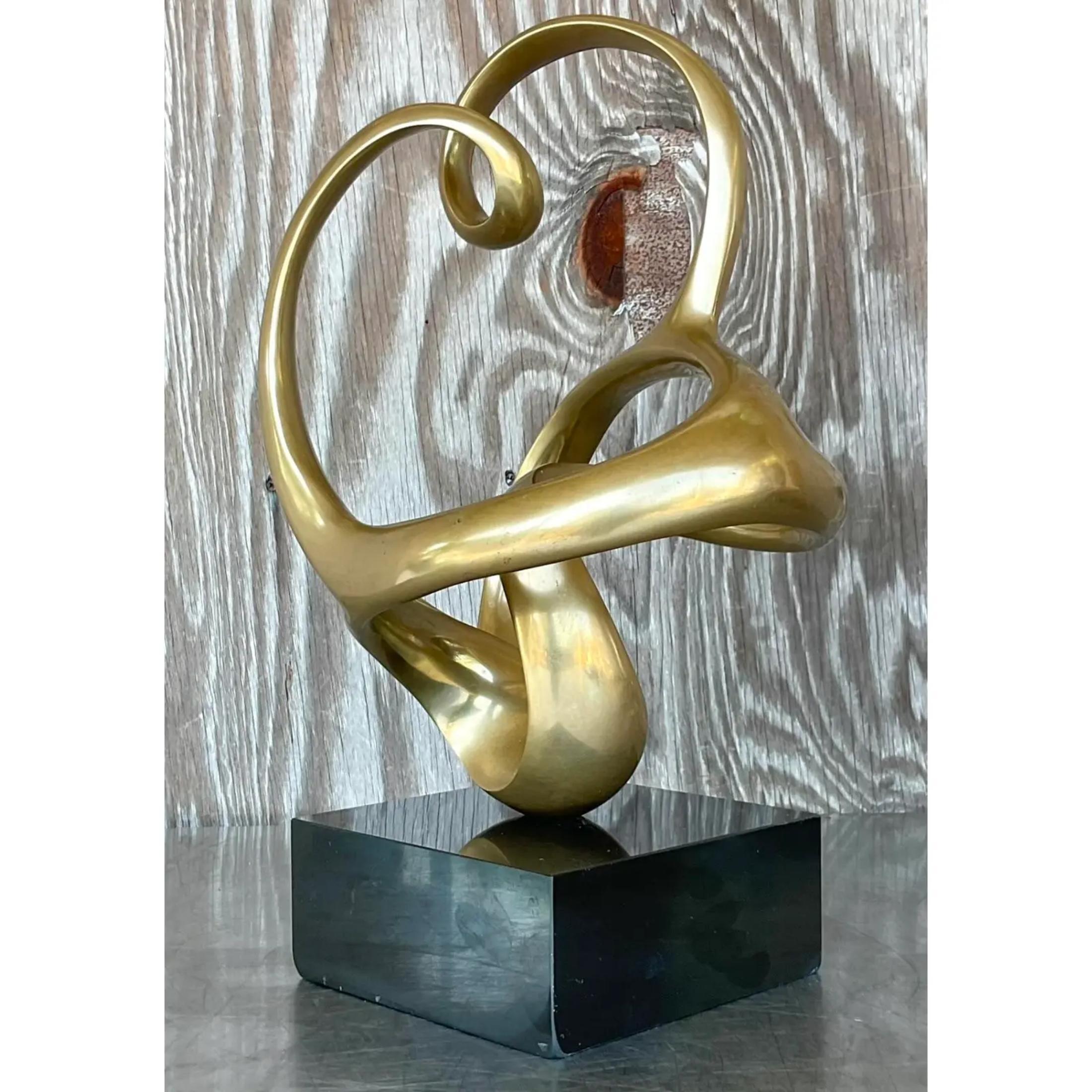 A stunning vintage Boho Brass sculpture. A chic Abstract composition forges in brass. Rests on a black wooden plinth. Signed by the artist. Acquired from a Palm Beach estate.
