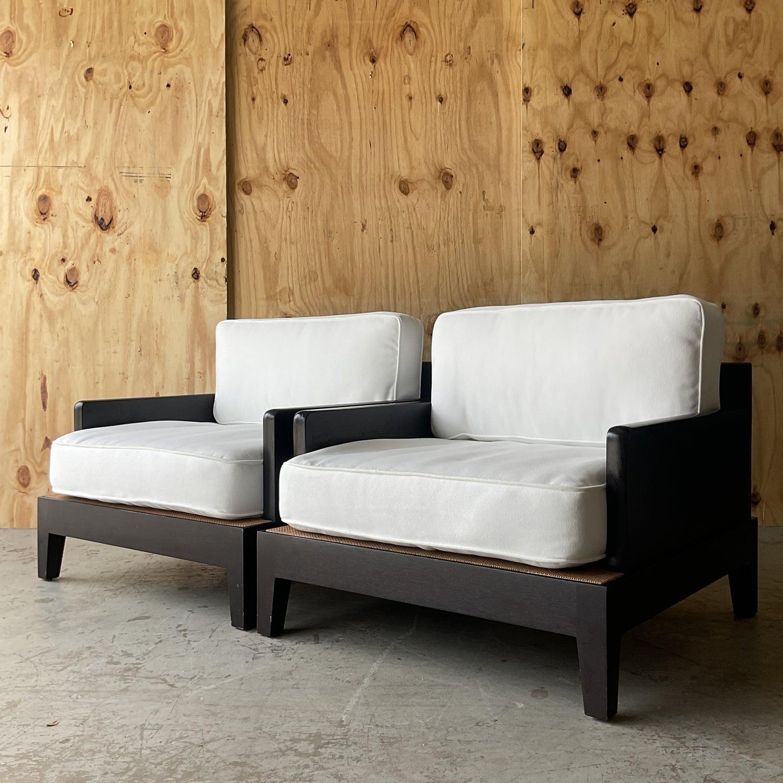 An exceptional pair of vintage Boho lounge chairs. Designed by Christian Liaigre for Holly Hunt. The coveted “Opium” style. A chic ebony wood frame with loose upholstered cushions. Tagged under the seats. Acquired from a Palm Beach estate. 