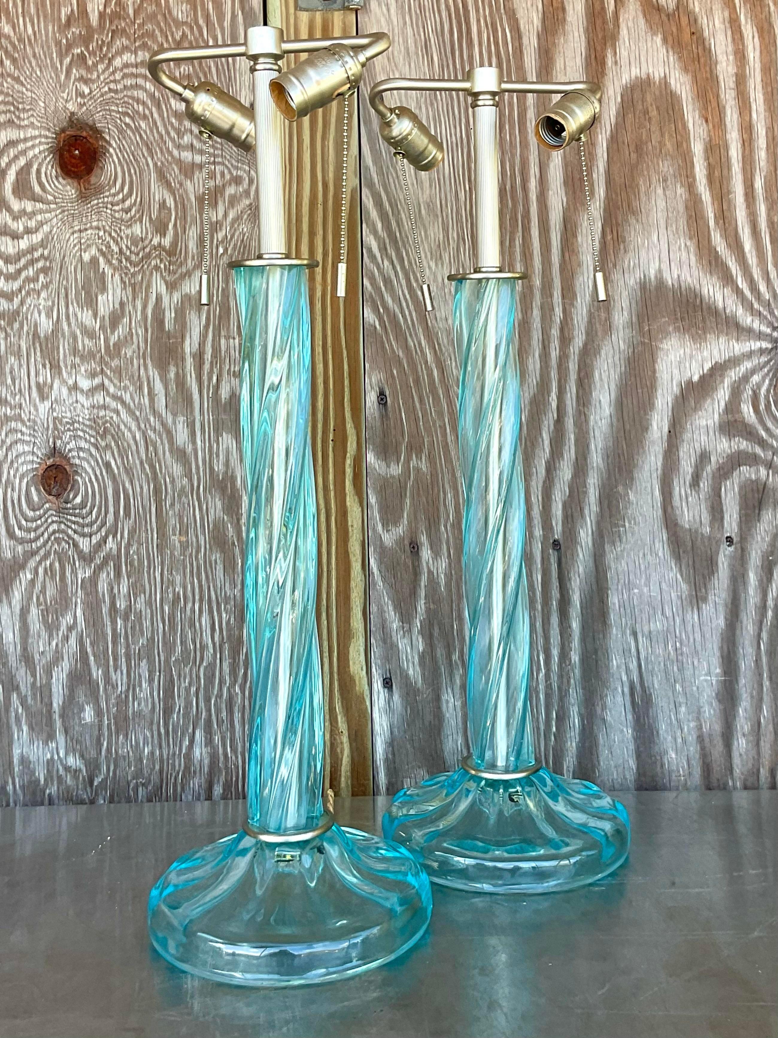 Illuminate your space with sophistication and flair using our Vintage Boho Signed Donghia Blown Twist Glass Lamps - A Pair. Handcrafted by American artisans, these exquisite lamps blend the timeless elegance of blown glass with the eclectic charm of
