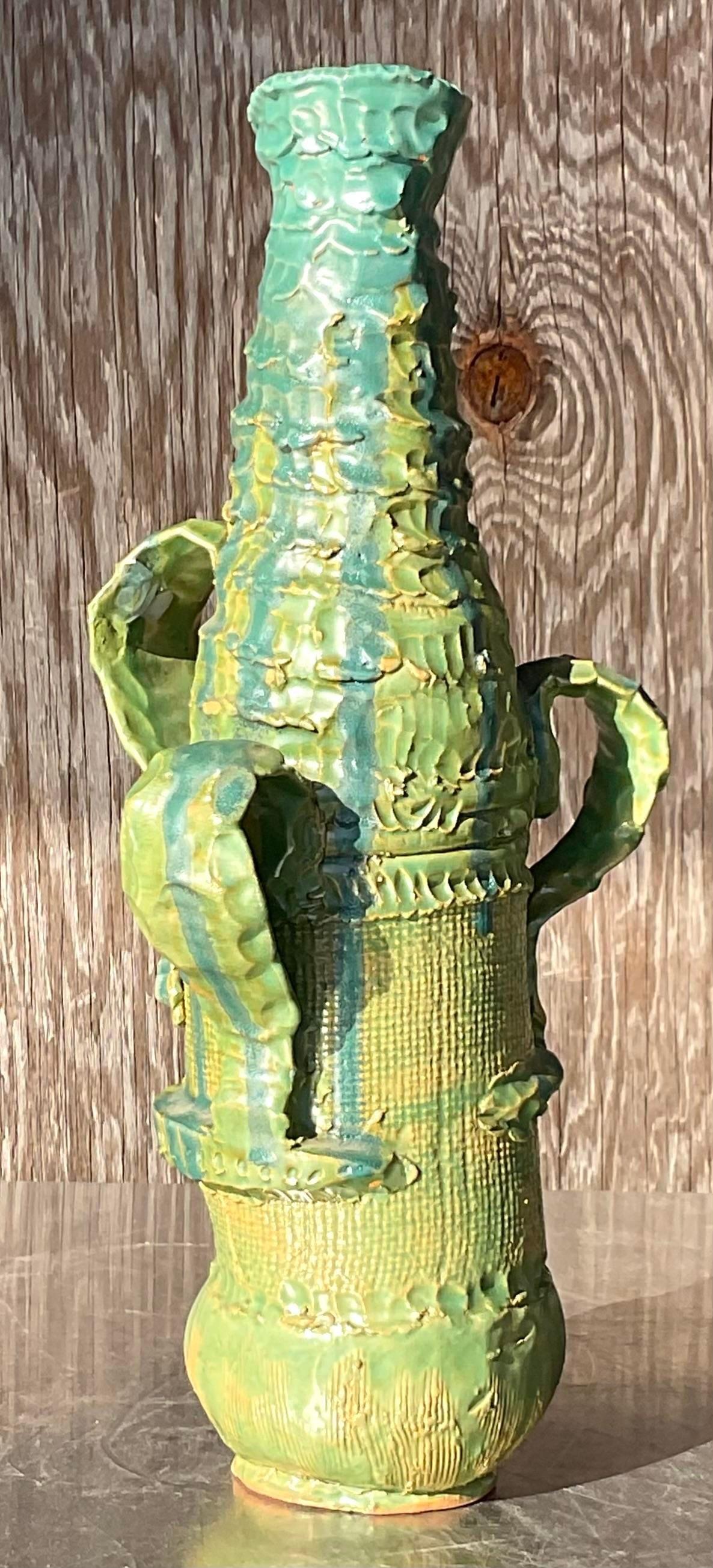A fantastic vintage Boho studio pottery vase. A beautiful hand made vessel in brilliant shades of green. Signed on the bottom. Acquired from a Palm Beach estate.