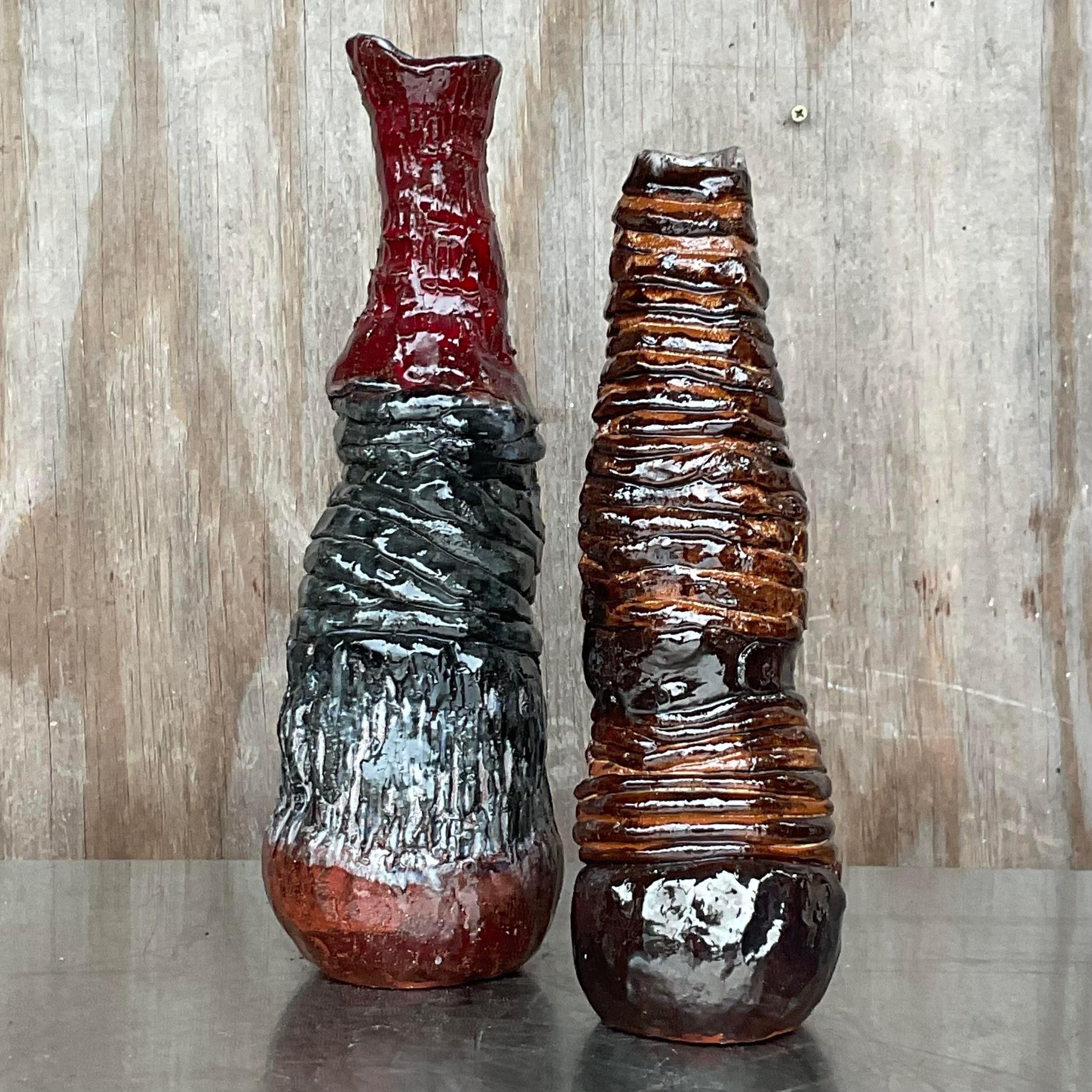 A fantastic pair of Boho Studio pottery vases. Beautiful hand made pieces in beautiful warm colors. Signed by the artist. Acquired from a NY estate.
