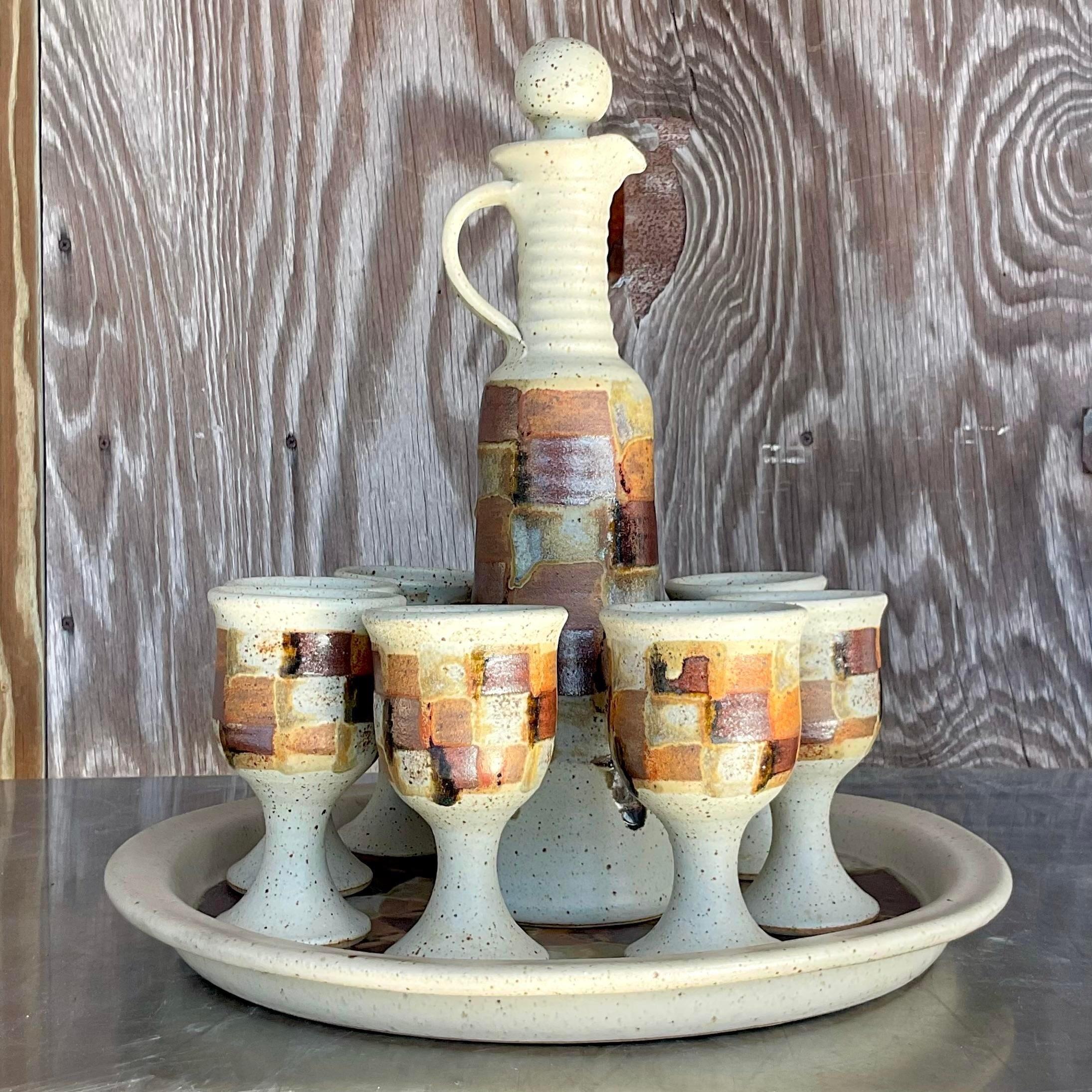 A stunning vintage Boho decanter set. A chic hand painted checkerboard in deep warm colors. A beautiful tall carafe with 8 matching goblets and coordinating tray. Acquired from a Palm Beach estate.

Platter size 16x16x1.5
Goblet size 3.25x3.25x5.75