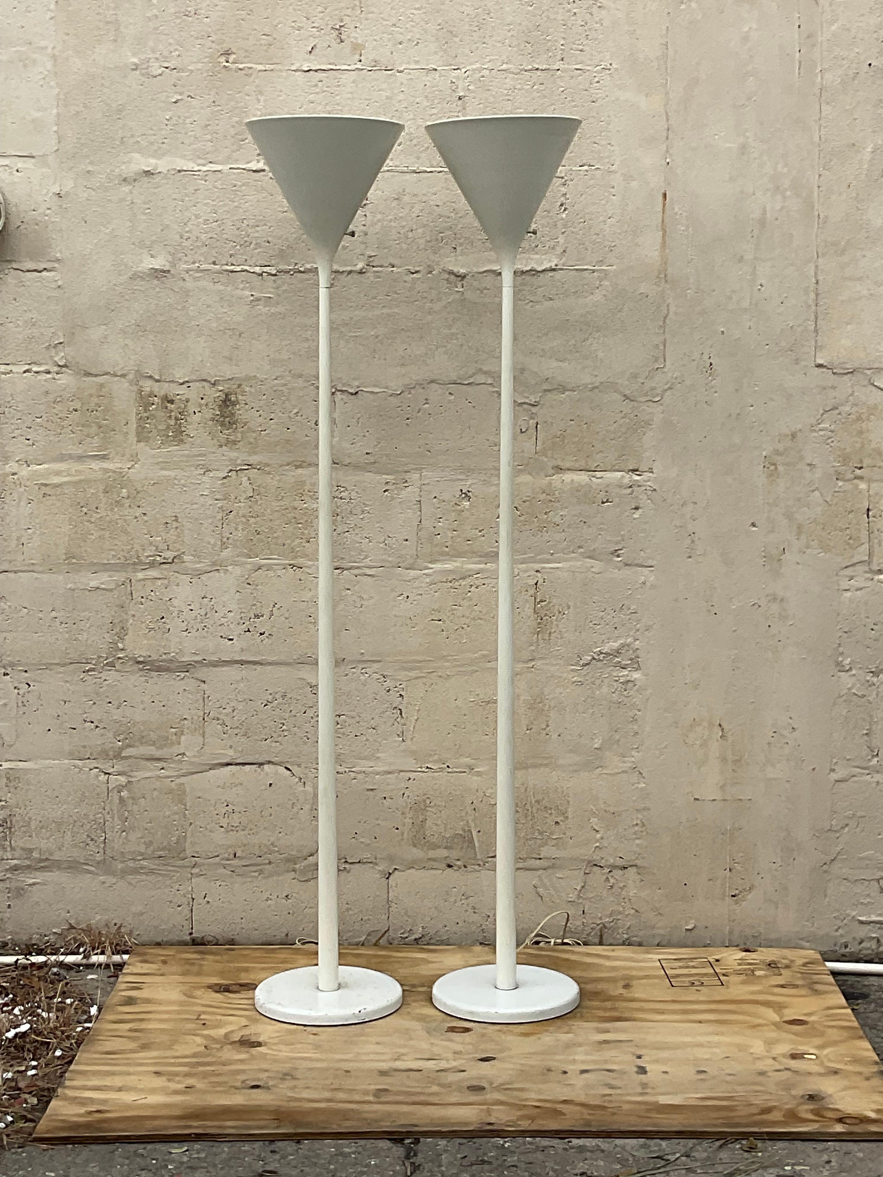 A fantastic pair of vintage Boho floor lamps. A chic 80s classic cone shape in a clean and modern design. Made by the Nessen group and signed on the bottom. Acquired from a Palm Beach estate. 