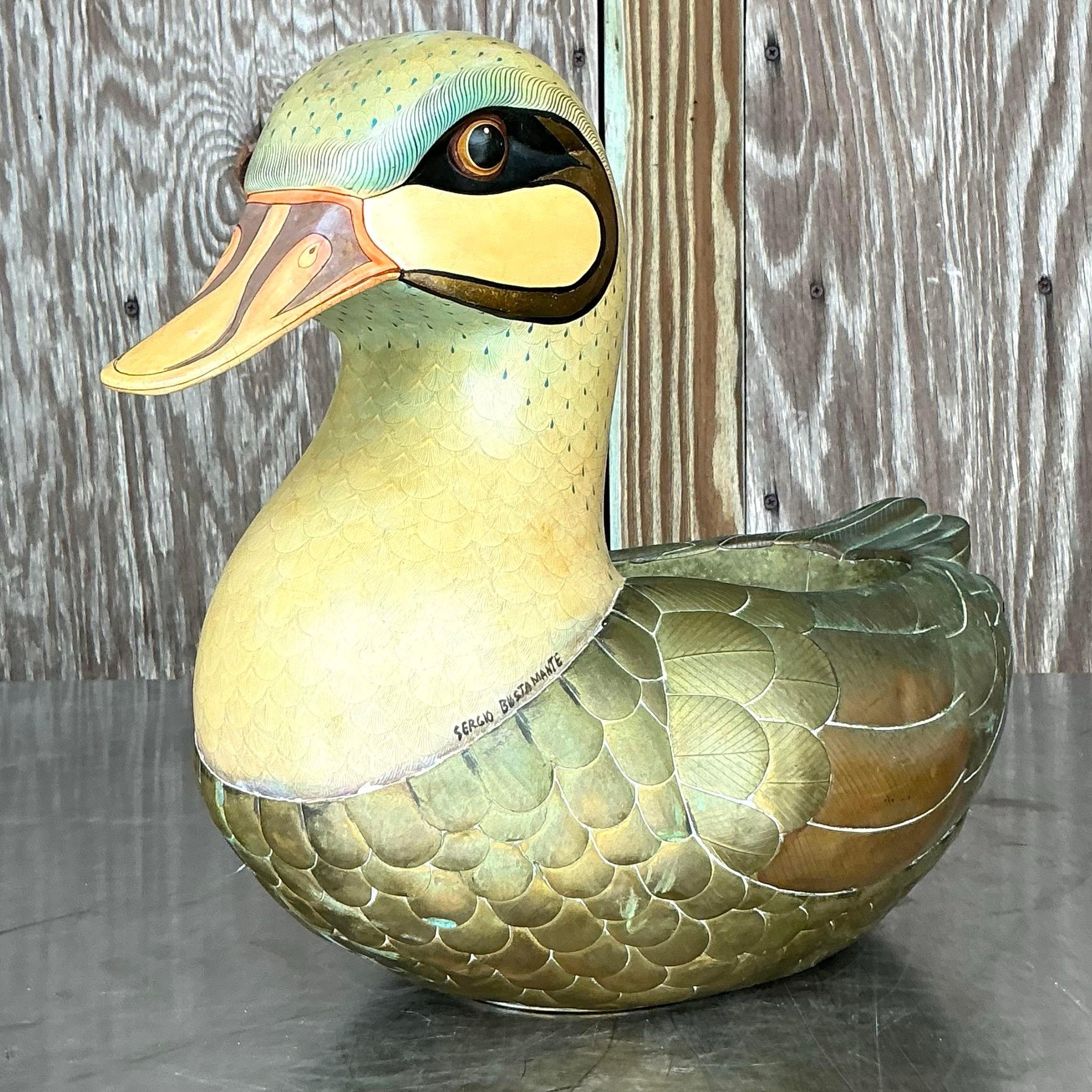 Introduce whimsical charm to your space with this vintage Boho signed Sergio Bustamante duck planter. Featuring a unique and playful design, this handcrafted piece showcases the artistry of Bustamante with intricate details and vibrant colors.