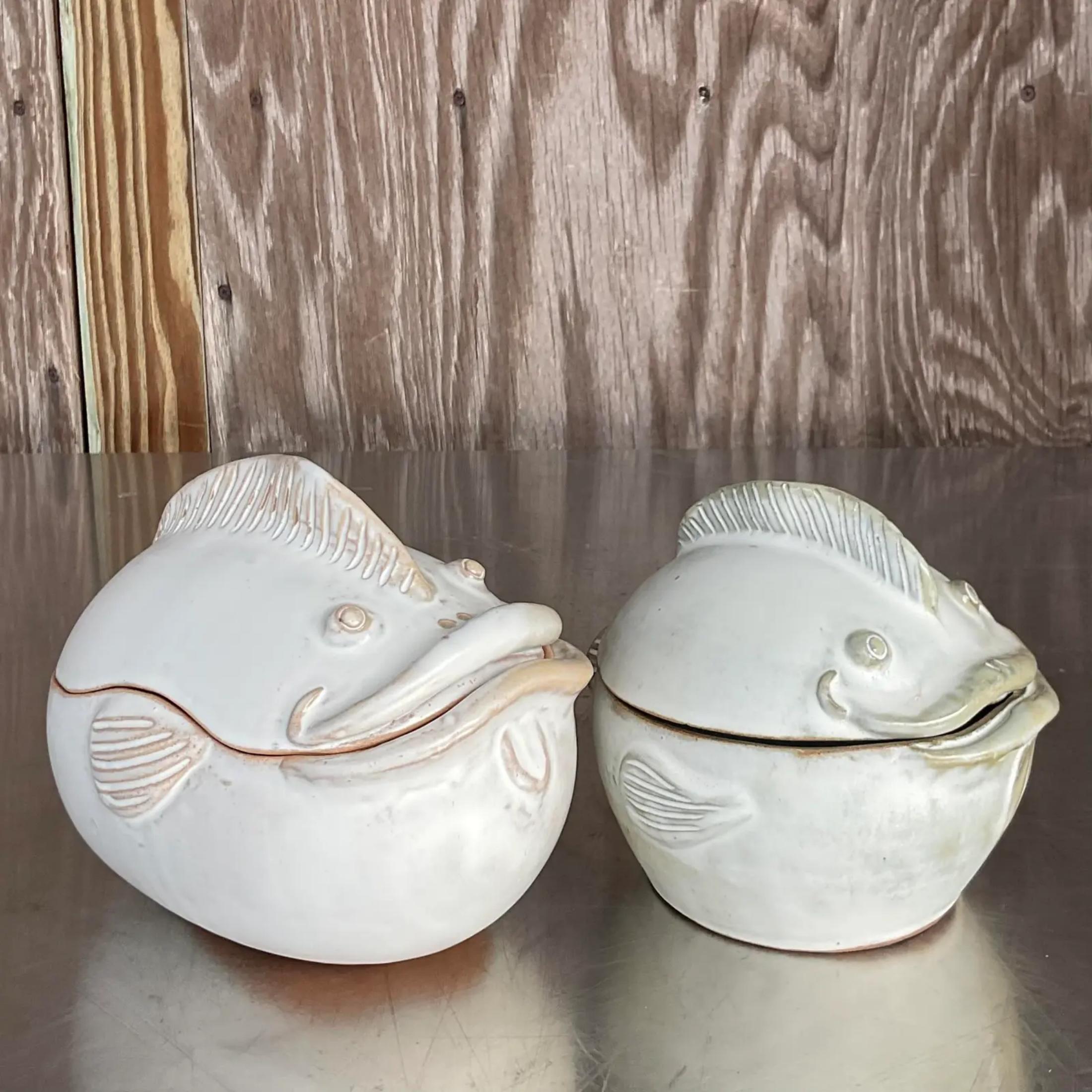 A charming pair of signed studio pottery lidded bowls. Two handsome fish with great expressions. Signed on the bottom. A third larger matching piece also available on my Chairish page. Acquired from a Palm Beach estate