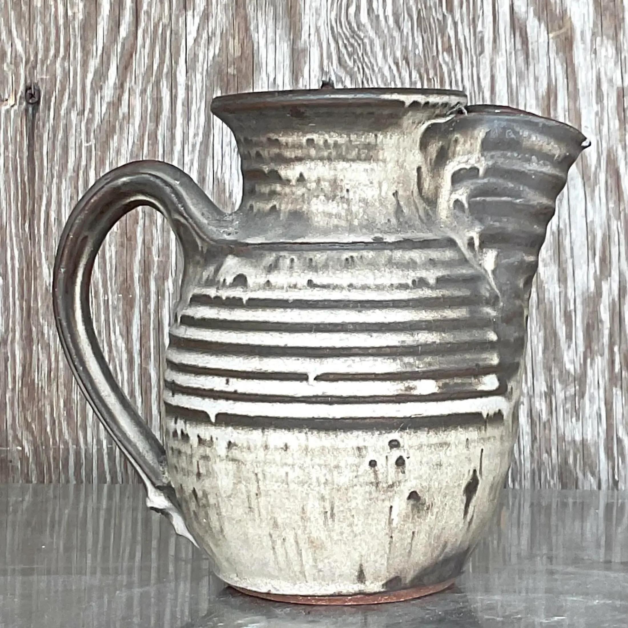A fantastic vintage boho pitcher. A chic matte glazed studio pottery completion. Signed in the bottom. Acquired from a Palm Beach estate