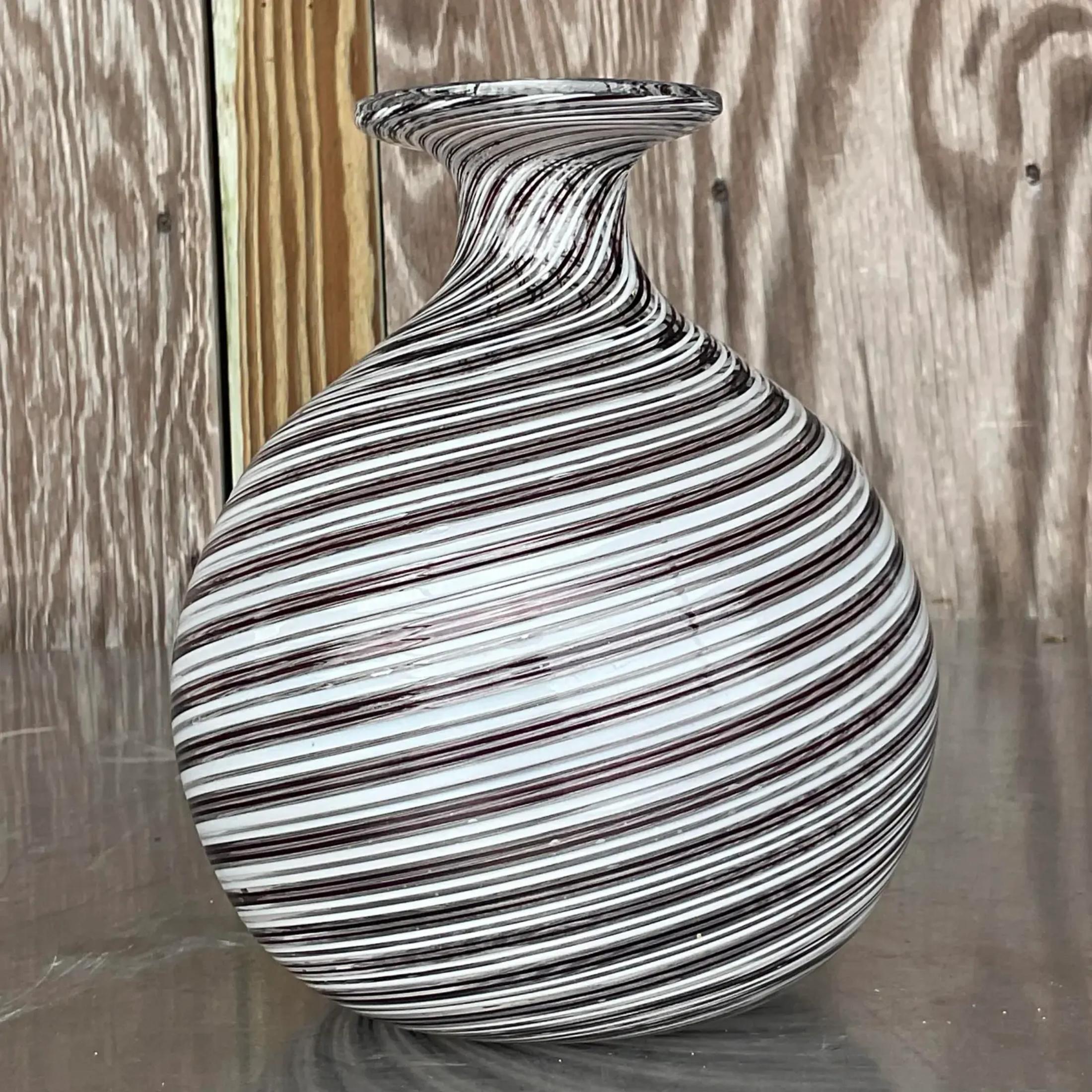 A fabulous vintage Boho Art glass vase. A chic swirl design in graphic black and white. Signed and numbered on the bottom. Acquired from a Miami estate