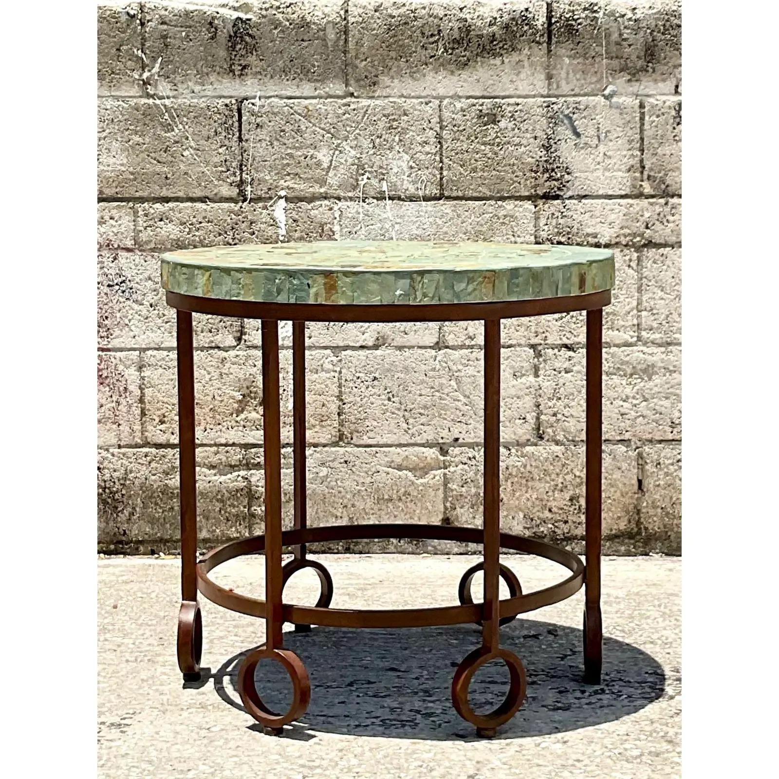 Fantastic vintage boho side table. Incredible distressed rusty frame in a circle design. Small tile slate top in the most beautiful green color. Acquired from a Palm Beach estate.
