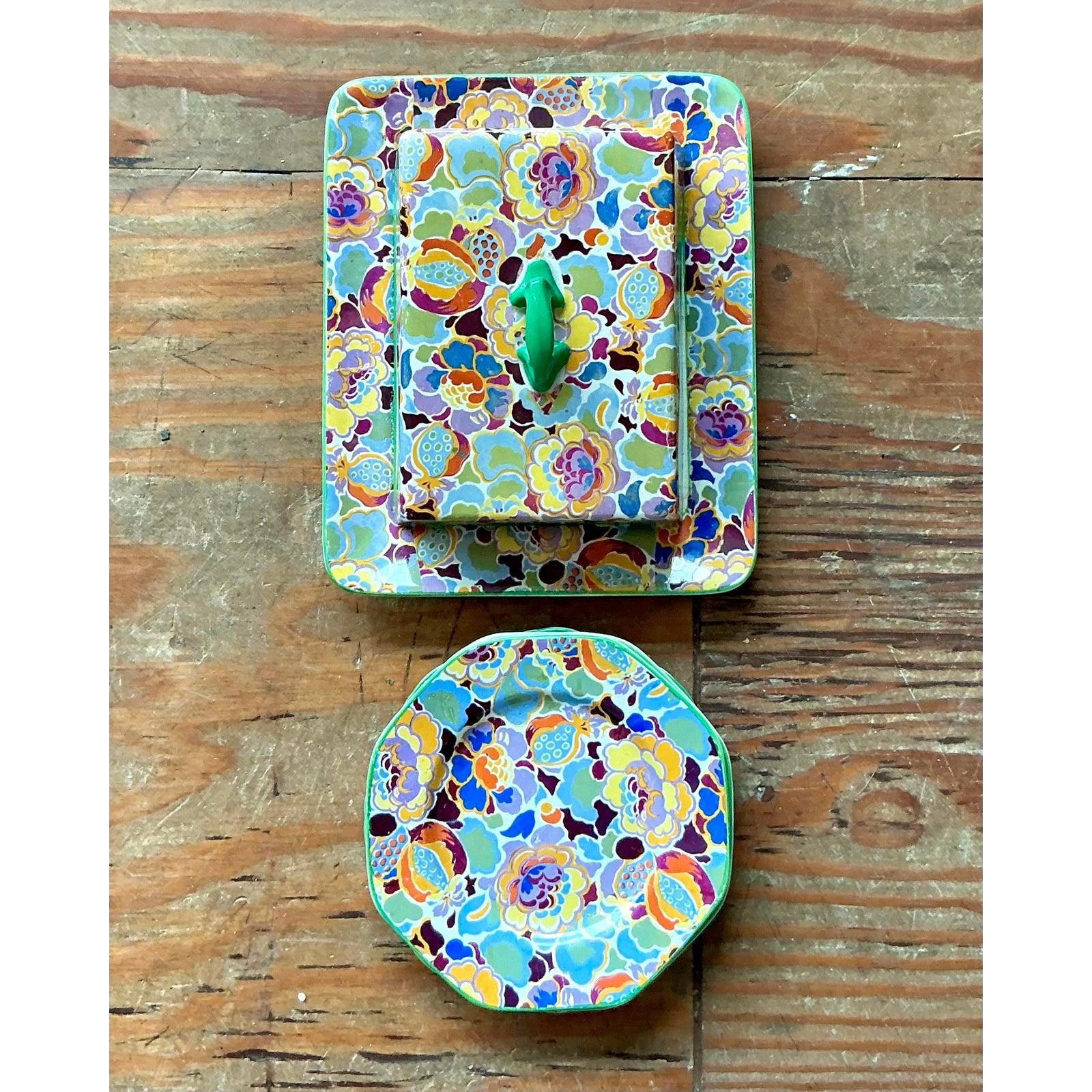 Infuse your morning routine with vibrant, bohemian charm with this delightful vintage Soho Pottery breakfast set. This collection features an eye-catching butter dish and four coordinating small plates/coasters, all adorned with a captivating floral