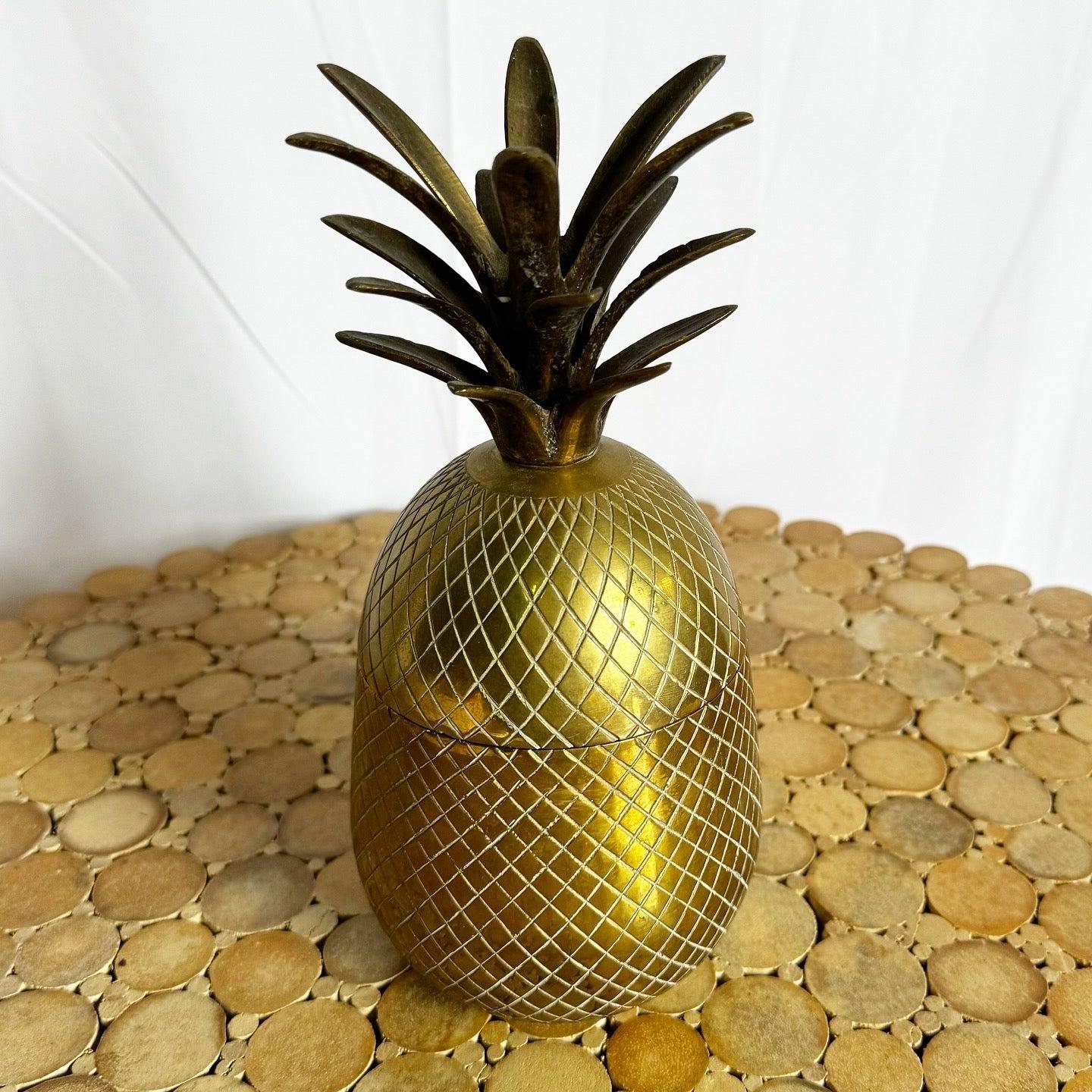 Vintage Brass Pineapple Container with lidded design and intricate detailing, perfect for adding tropical charm or storing small items.
 
 We sell items as acquired, without restoring or repairing. Vintage pieces may have age-related wear. Review