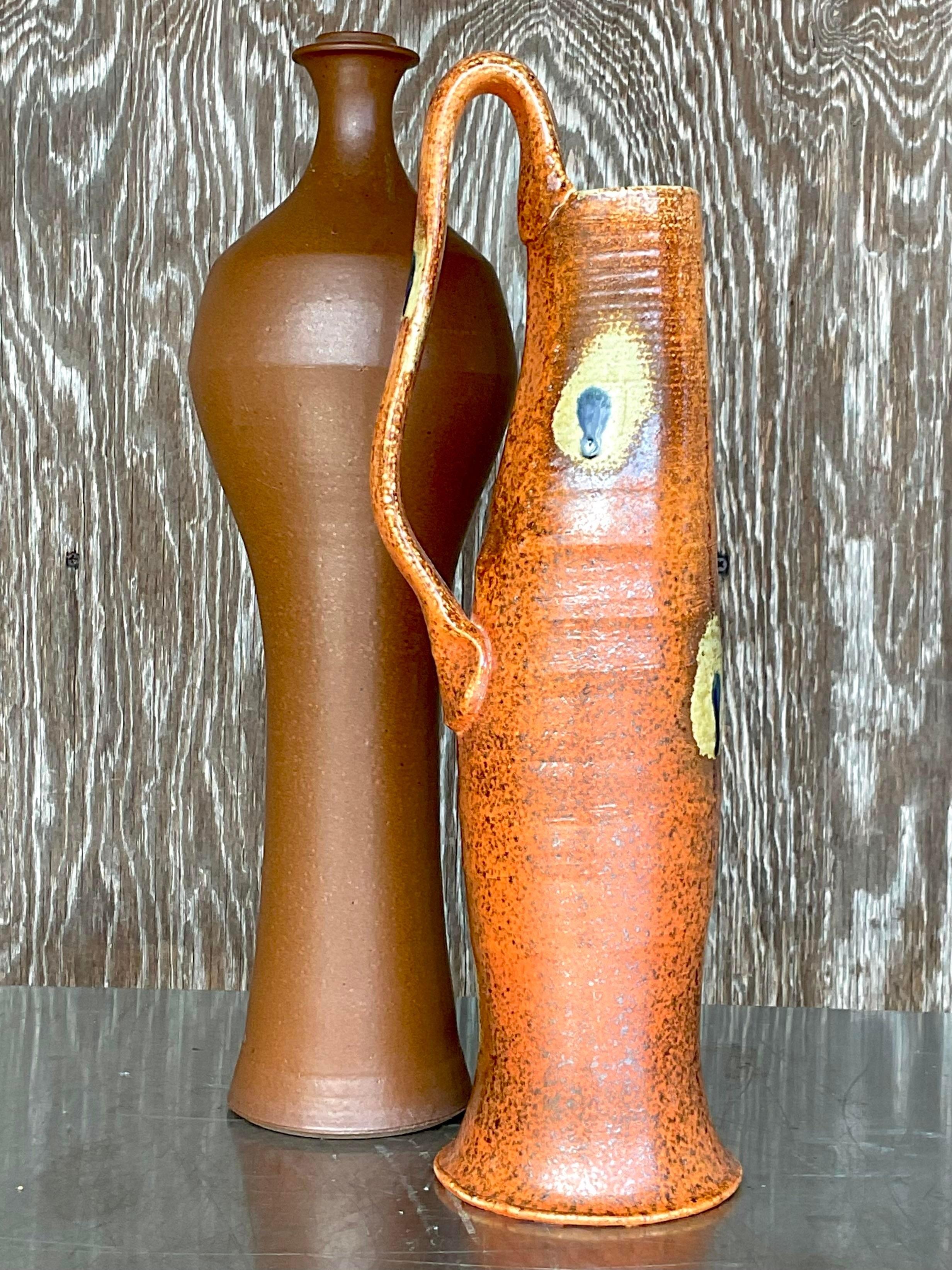 A fantastic set of two vintage vases. Each hand made studio pottery designs and each signed by the artists. Incredible attention to detail and gorgeous glazed finishes. Tall and impressive.

Small vase 6x5x18