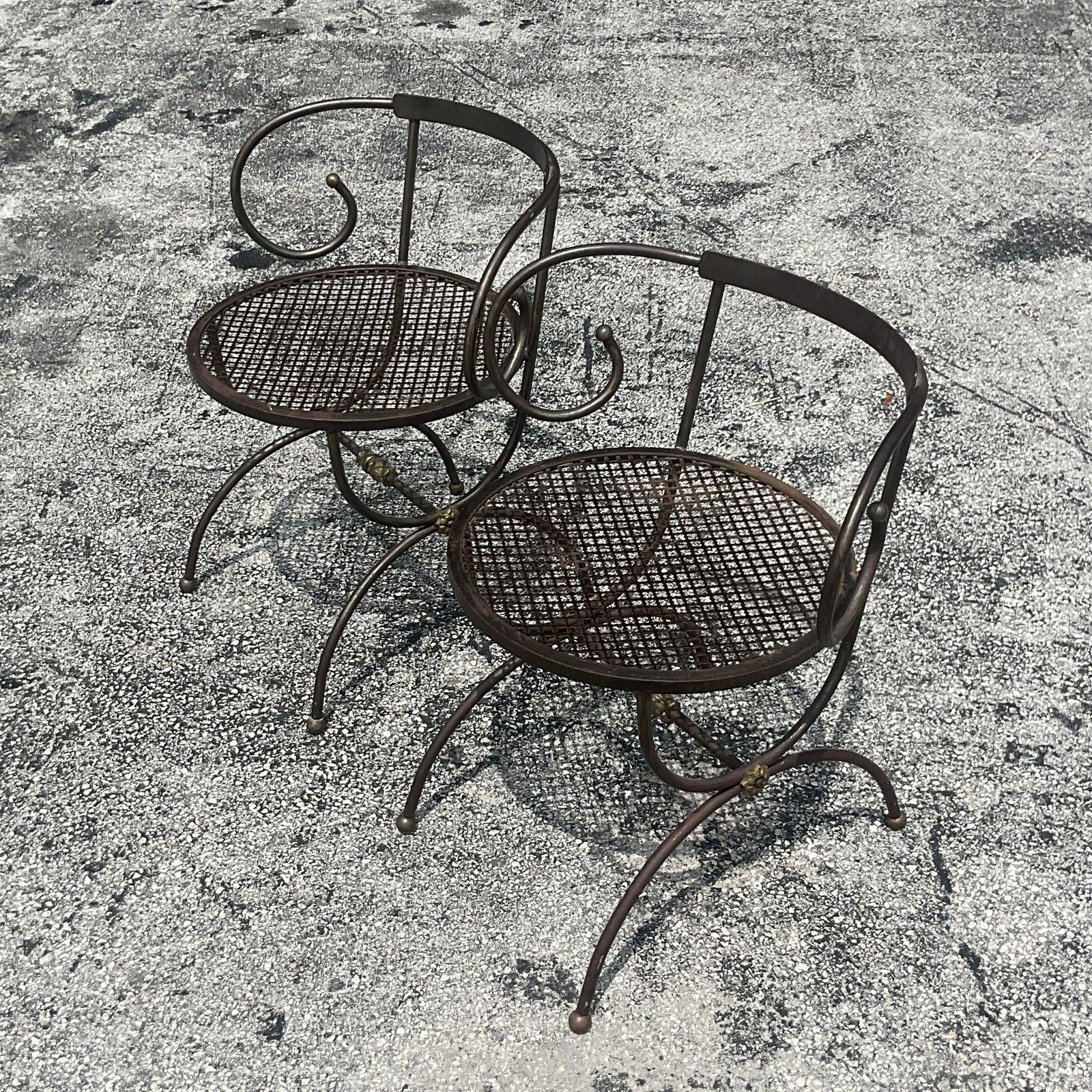 A fabulous pair of vintage Boho side chairs. A chic metal construction in a charming swirl design. Perfect indoors our outside. Acquired from a Palm Beach estate.