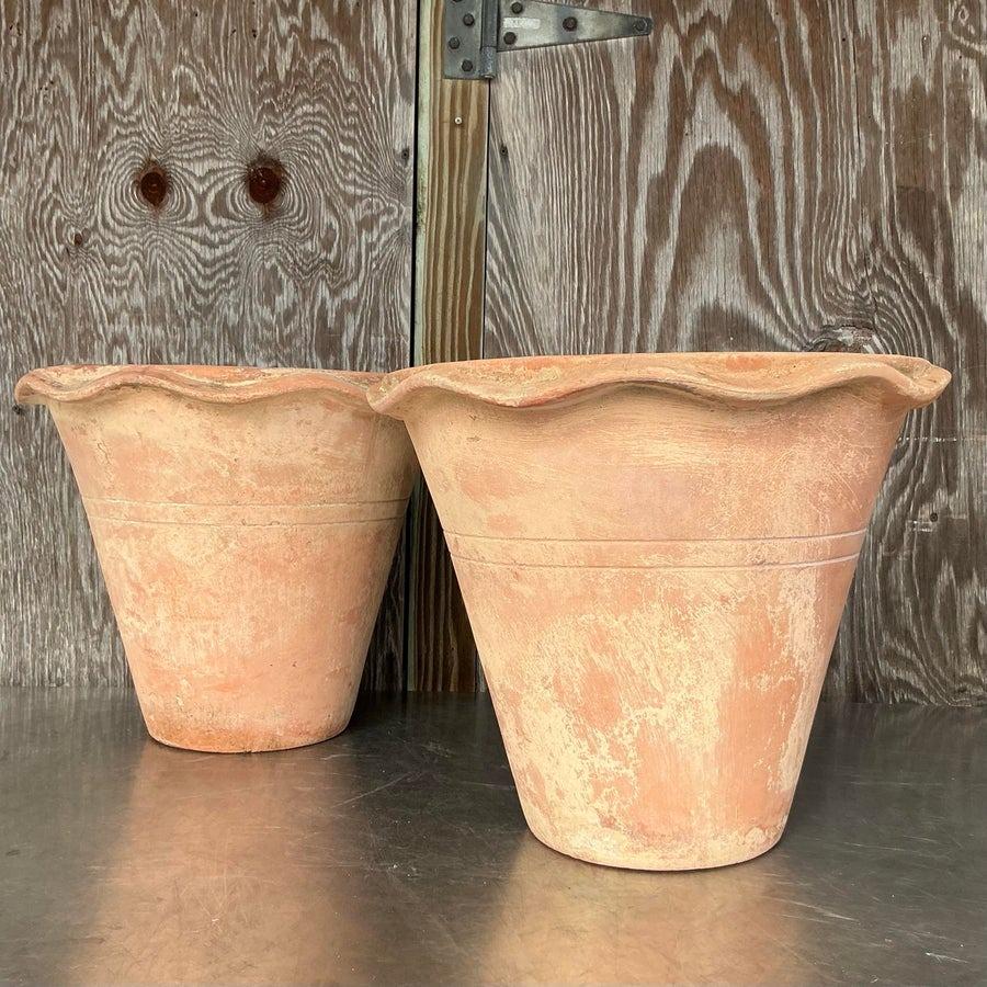 Enhance your space with this pair of vintage boho terra cotta over fiberglass planters. Combining the rustic charm of terra cotta with the lightweight durability of fiberglass, these planters are both stylish and practical. Their earthy tones and