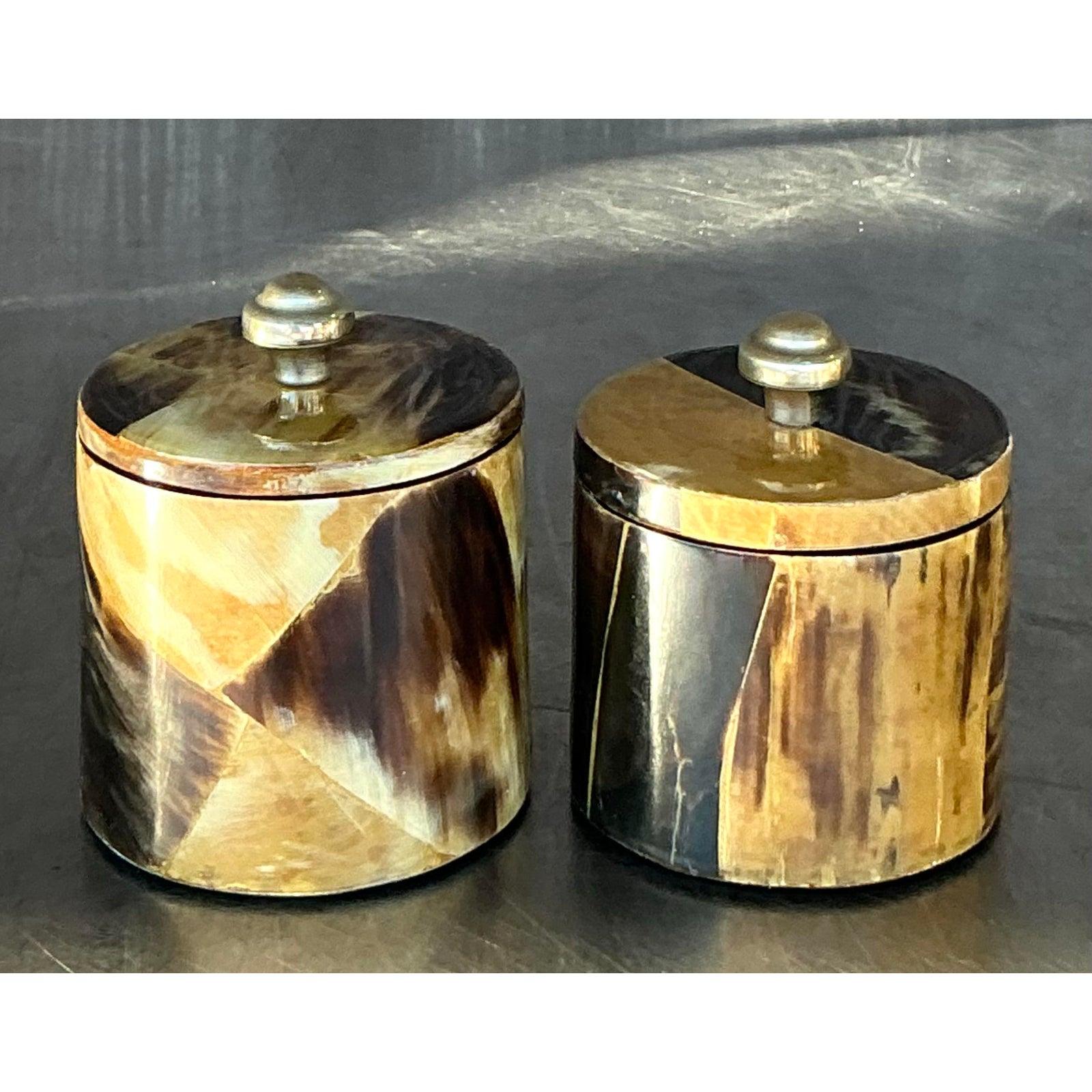 Enhance your decor with these Vintage Boho Tessellated Horn Canisters, a charming pair that blends natural elegance with bohemian flair. Crafted from beautifully tessellated horn, each canister features a striking mosaic of amber, cream, and deep