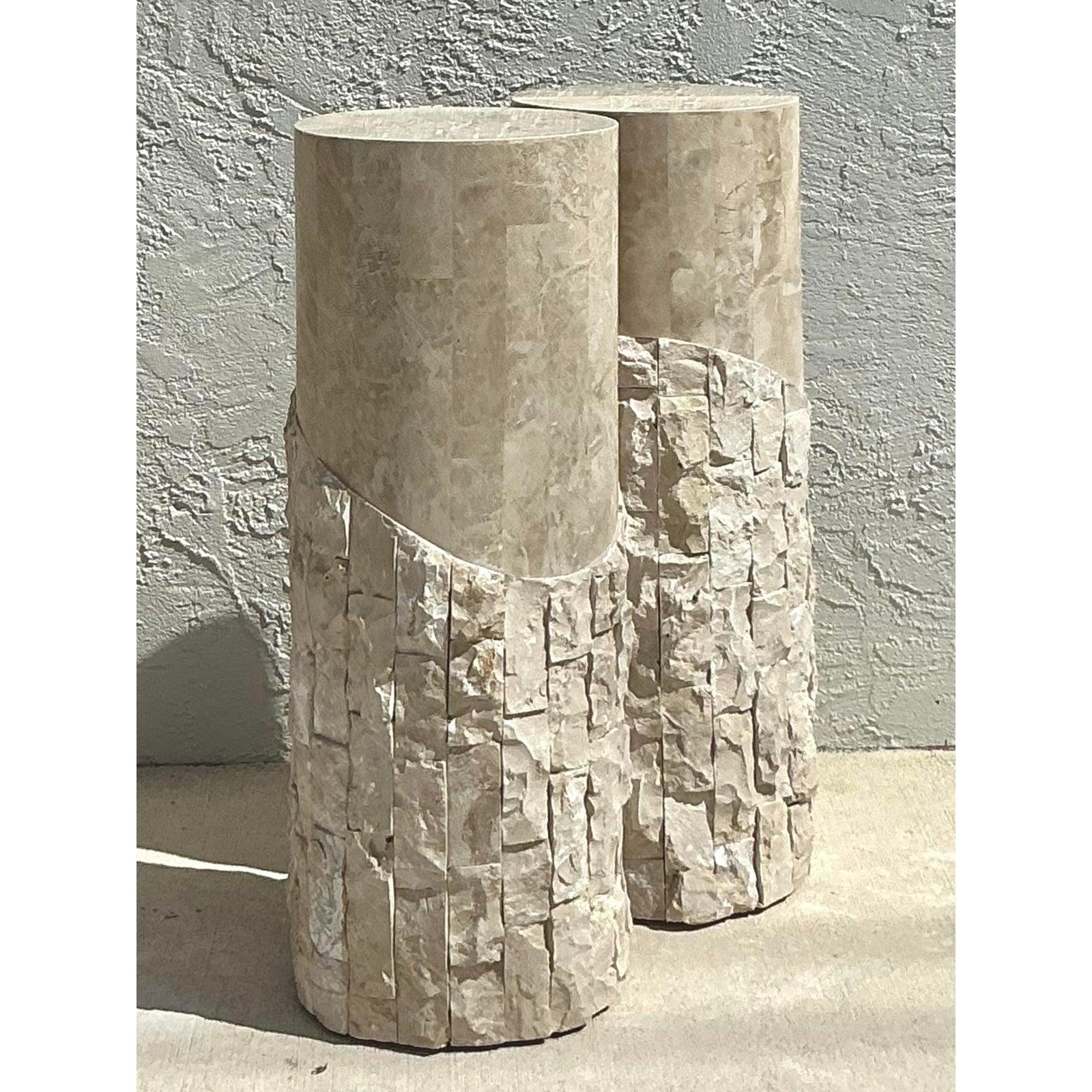 Presenting a stunning pair of vintage Boho tessellated stone pedestals, exquisite pieces that embody the sophisticated yet earthy aesthetic of the mid-20th century. Each pedestal is meticulously crafted with individually cut and tessellated stone