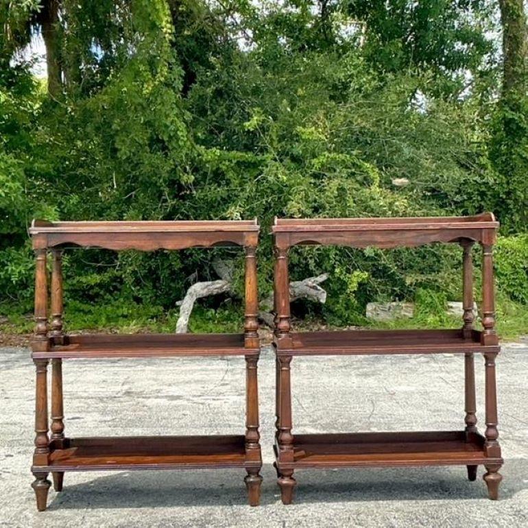 This pair of vintage Boho Theodore Alexander Castle Bromwich étagères features a sophisticated design with intricate details, perfect for adding a touch of timeless elegance and eclectic charm to your decor. Acquired from a Palm Beach estate.