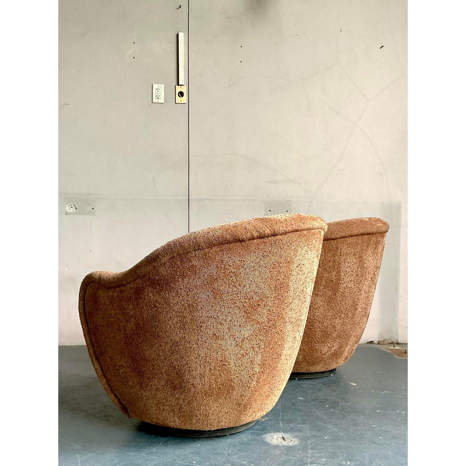 Immerse yourself in comfort and style with this exquisite pair of vintage Thomas Roderick biomorphic swivel chairs, a true testament to sophisticated bohemian design. Upholstered in a luxurious slubbed boucle fabric, these chairs feature organic,