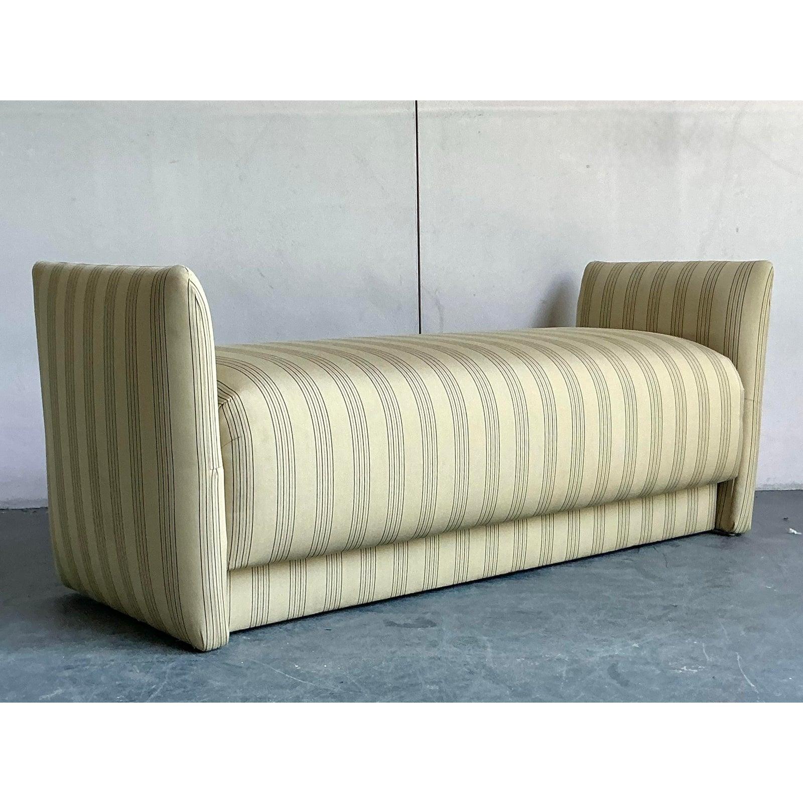 Introduce a touch of timeless charm to your home with this elegant upholstered bench. Featuring a classic silhouette with graceful, low-slung arms, this piece is beautifully tailored in a sophisticated ticking stripe fabric that feels both relaxed