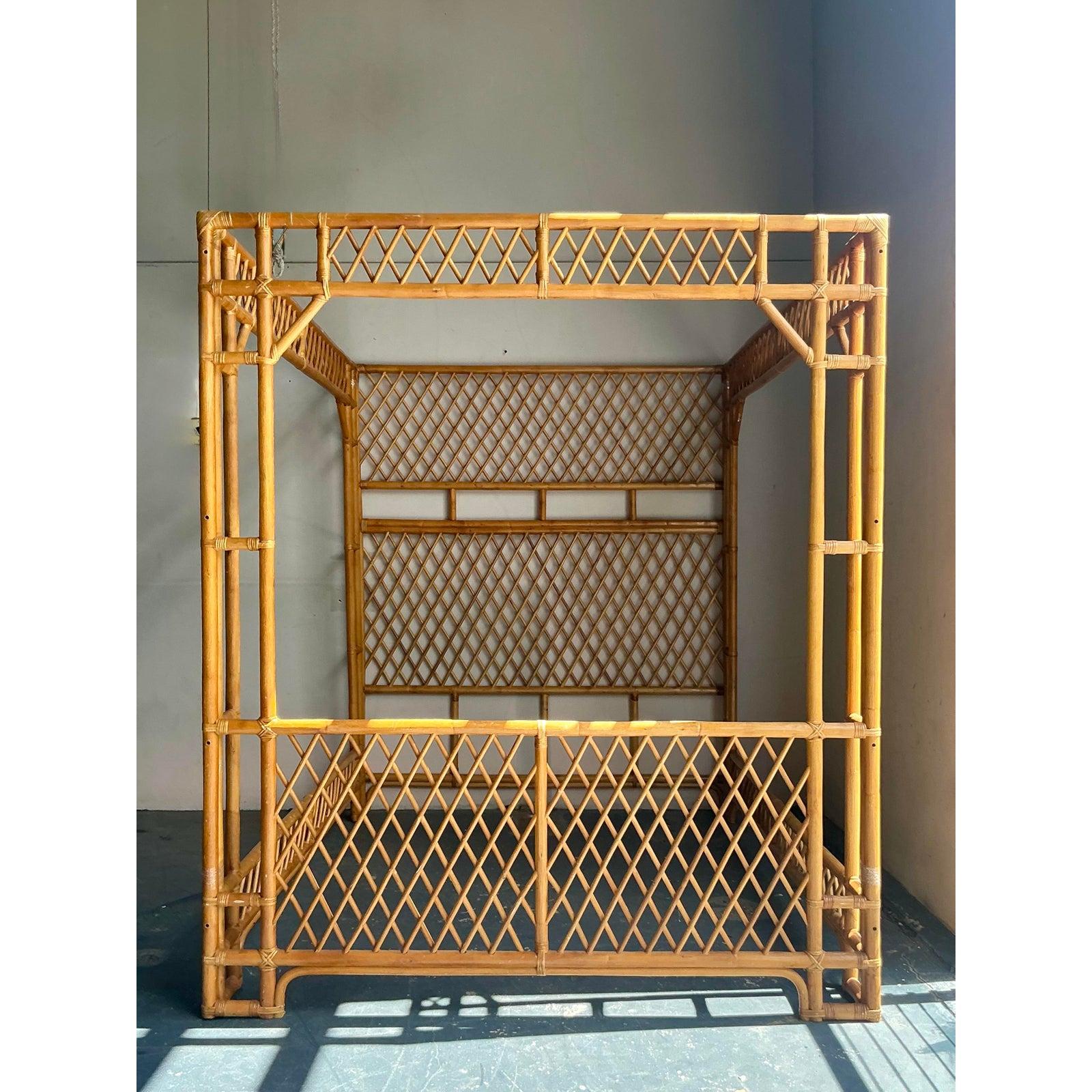 Commanding attention with its stunning craftsmanship and bohemian allure, this vintage queen-size canopy bed is a rare find for those seeking unique bedroom furniture. Constructed from warm, natural rattan and bamboo, the frame features an intricate