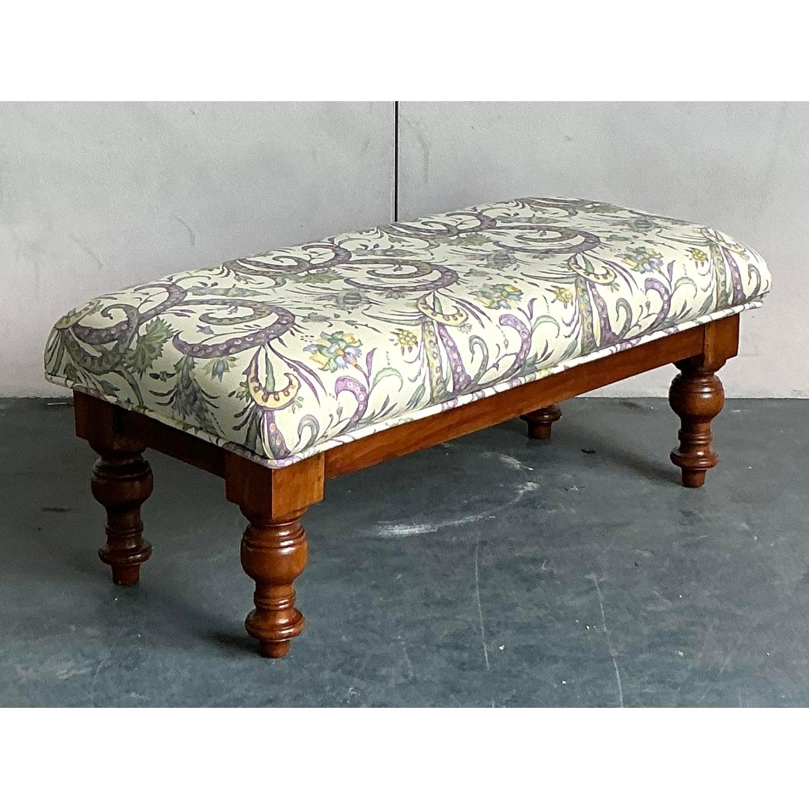 Introduce a touch of whimsical charm to your interior with this captivating upholstered bench. The piece is built on a foundation of classic English design, featuring a sturdy wood frame and four beautifully executed, substantial turned legs with a