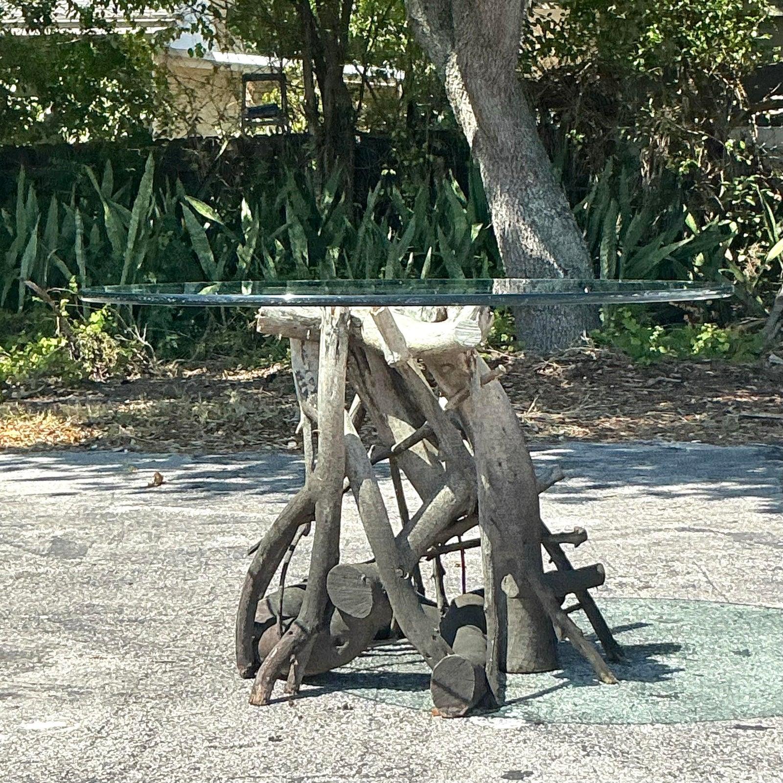 Infuse your space with the raw beauty of nature with this striking vintage boho twisted root center hall table. Featuring an intricately intertwined driftwood base, this sculptural piece brings an organic yet refined aesthetic to any interior.