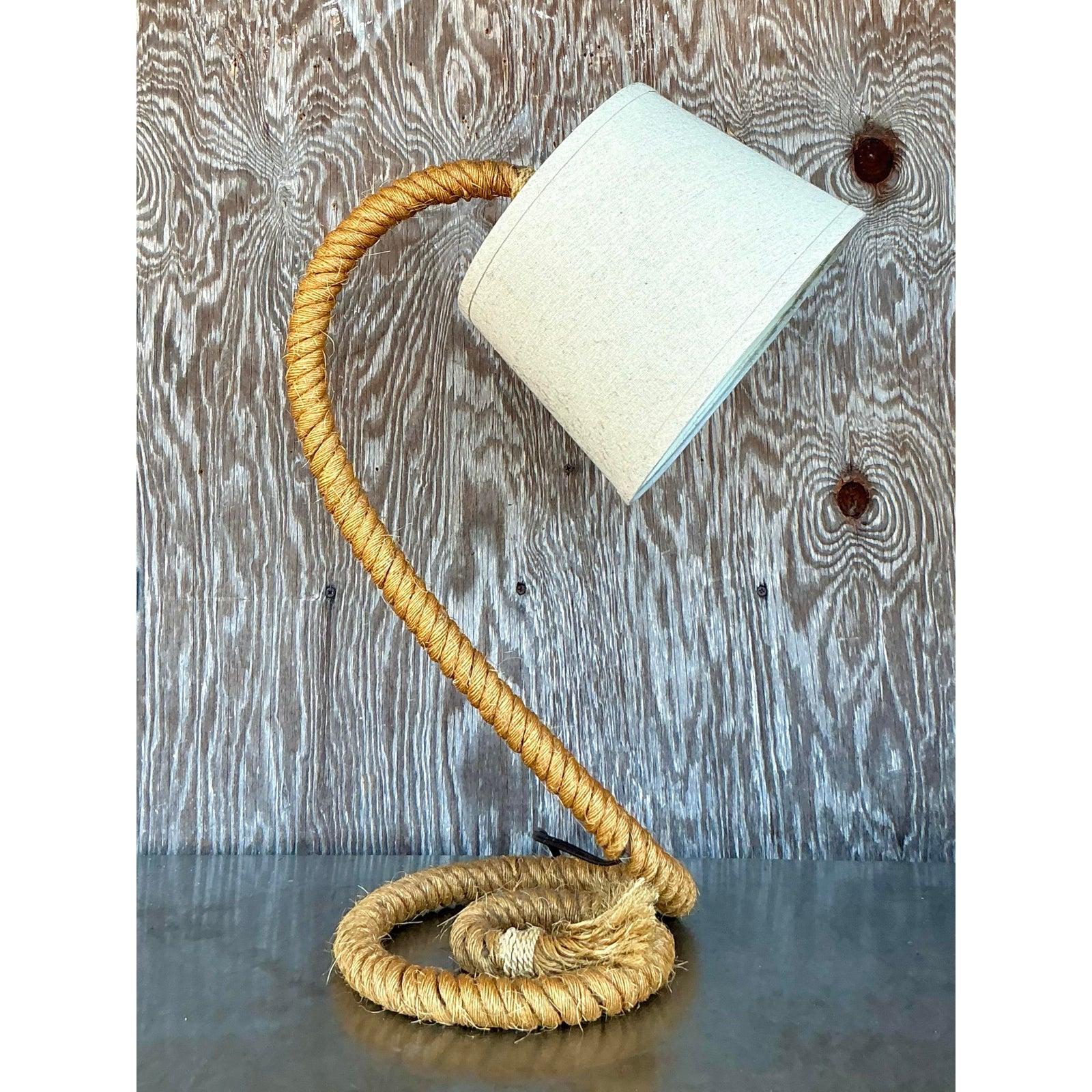 Illuminate your space with the unique texture and laid-back style of this vintage desk lamp, featuring a striking base crafted from thick, twisted rope. The natural material is artfully coiled or shaped to create a sculptural form that brings an