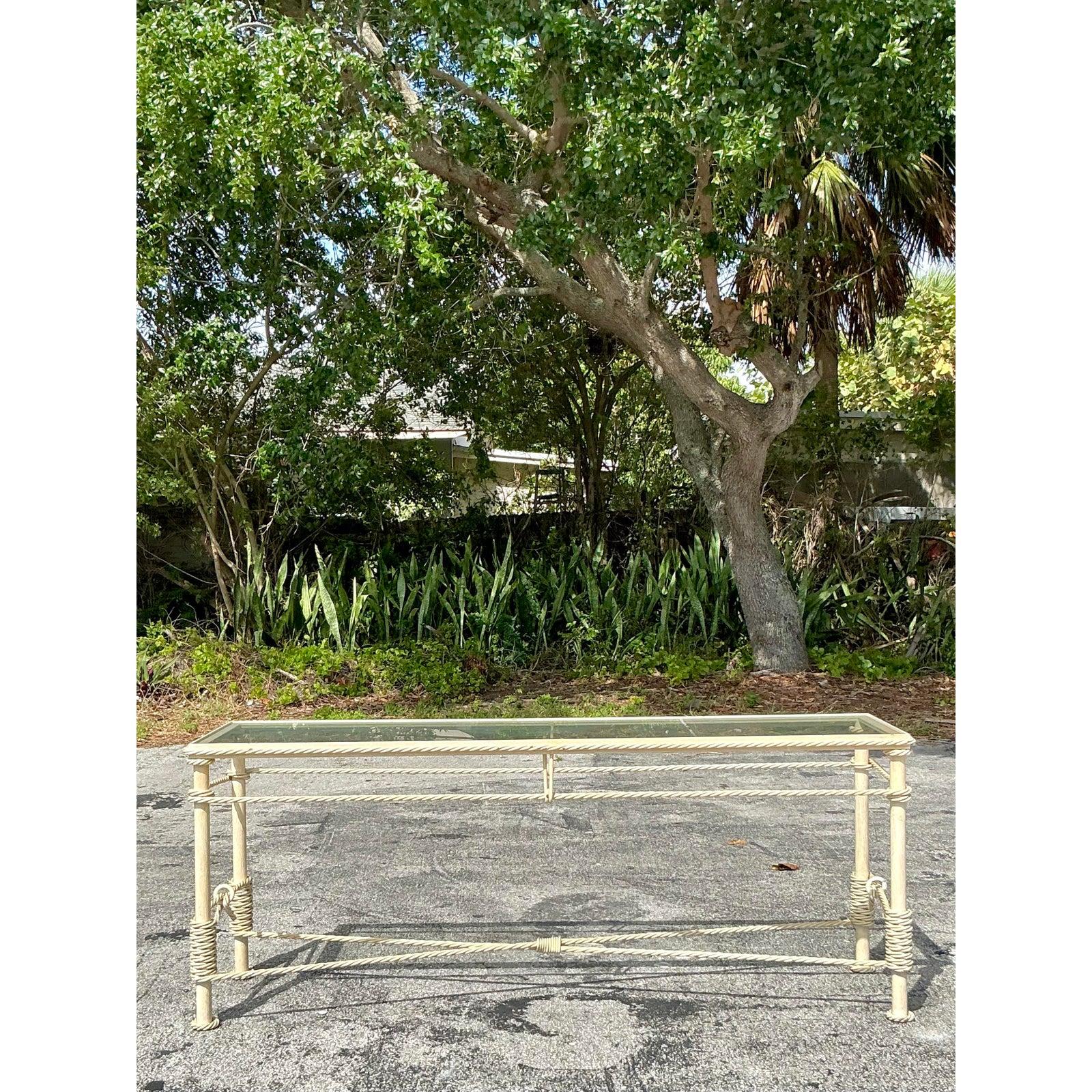 Elevate your space with this exquisite vintage Boho twisted wrought iron console table, a true testament to timeless craftsmanship and coastal charm. Featuring an intricately wrapped rope design in a light cream finish, this airy yet substantial