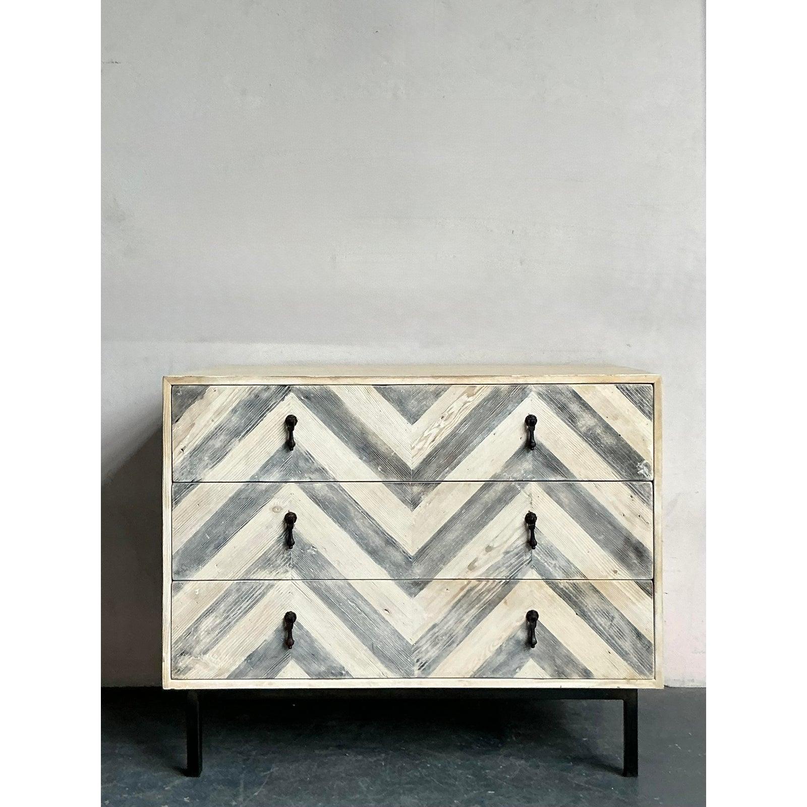 Introduce a touch of captivating texture and Bohemian elegance with this vintage chest of drawers, featuring a distinctive whitewash chevron pattern. Crafted from wood, the façade of this piece showcases an eye-catching herringbone design, with