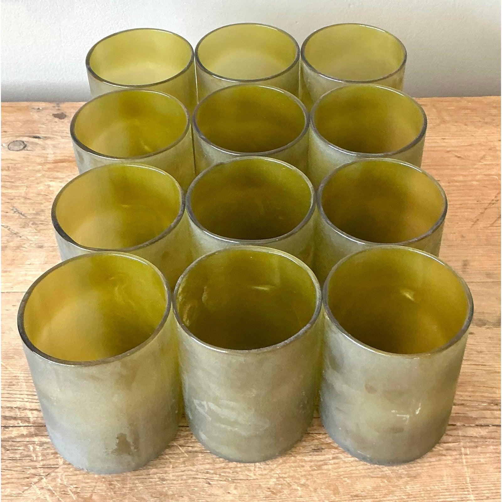 Embrace sustainable style with this exceptional set of twelve vintage Boho rocks glasses, ingeniously crafted from recycled wine bottles. Each glass showcases a unique chartreuse green hue, reflecting an eco-conscious design ethos that adds a