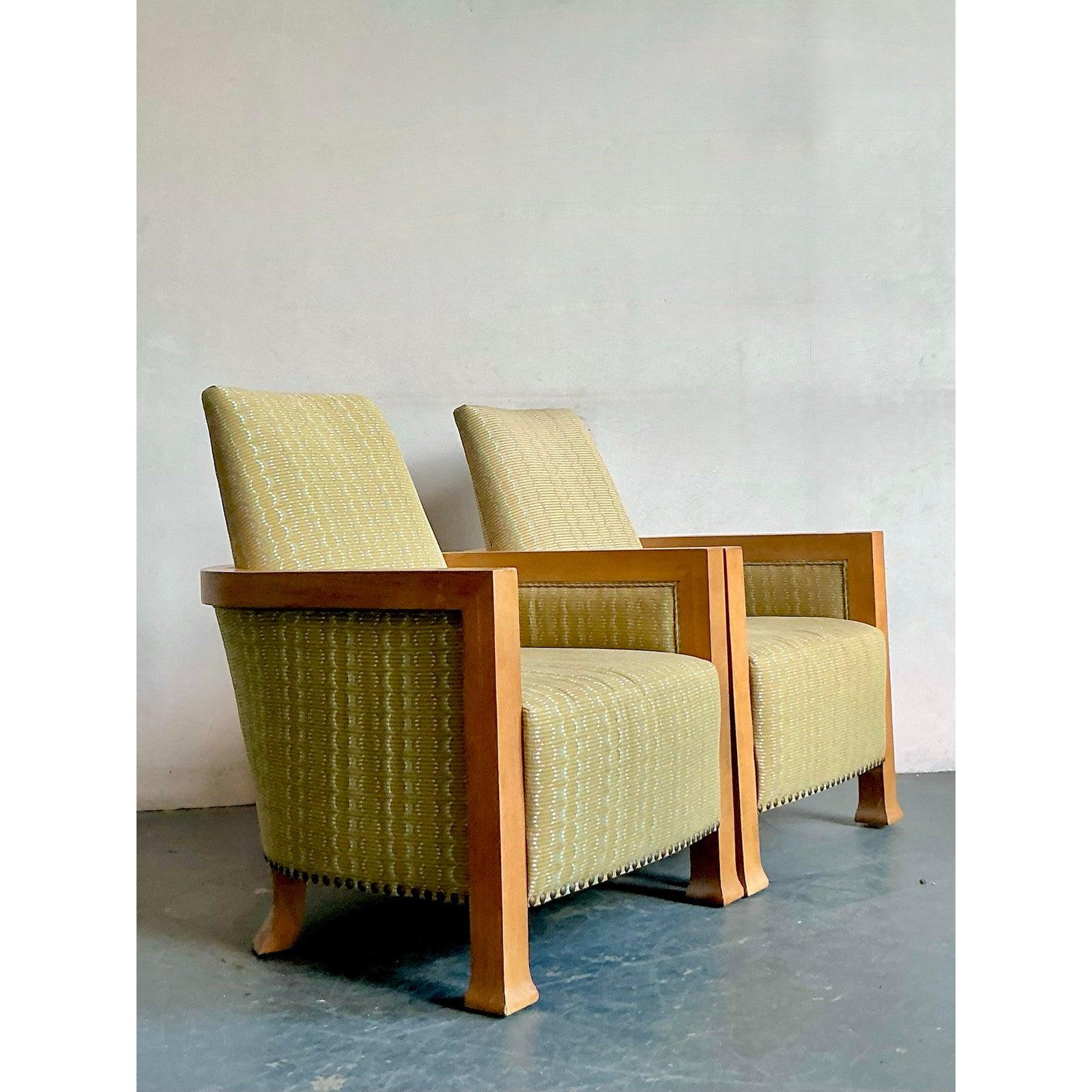 Discover this charming pair of vintage lounge chairs, perfect for adding a touch of bohemian elegance and comfortable seating to any space. Featuring robust wood frames with a warm, natural finish, these chairs embody a relaxed yet sophisticated