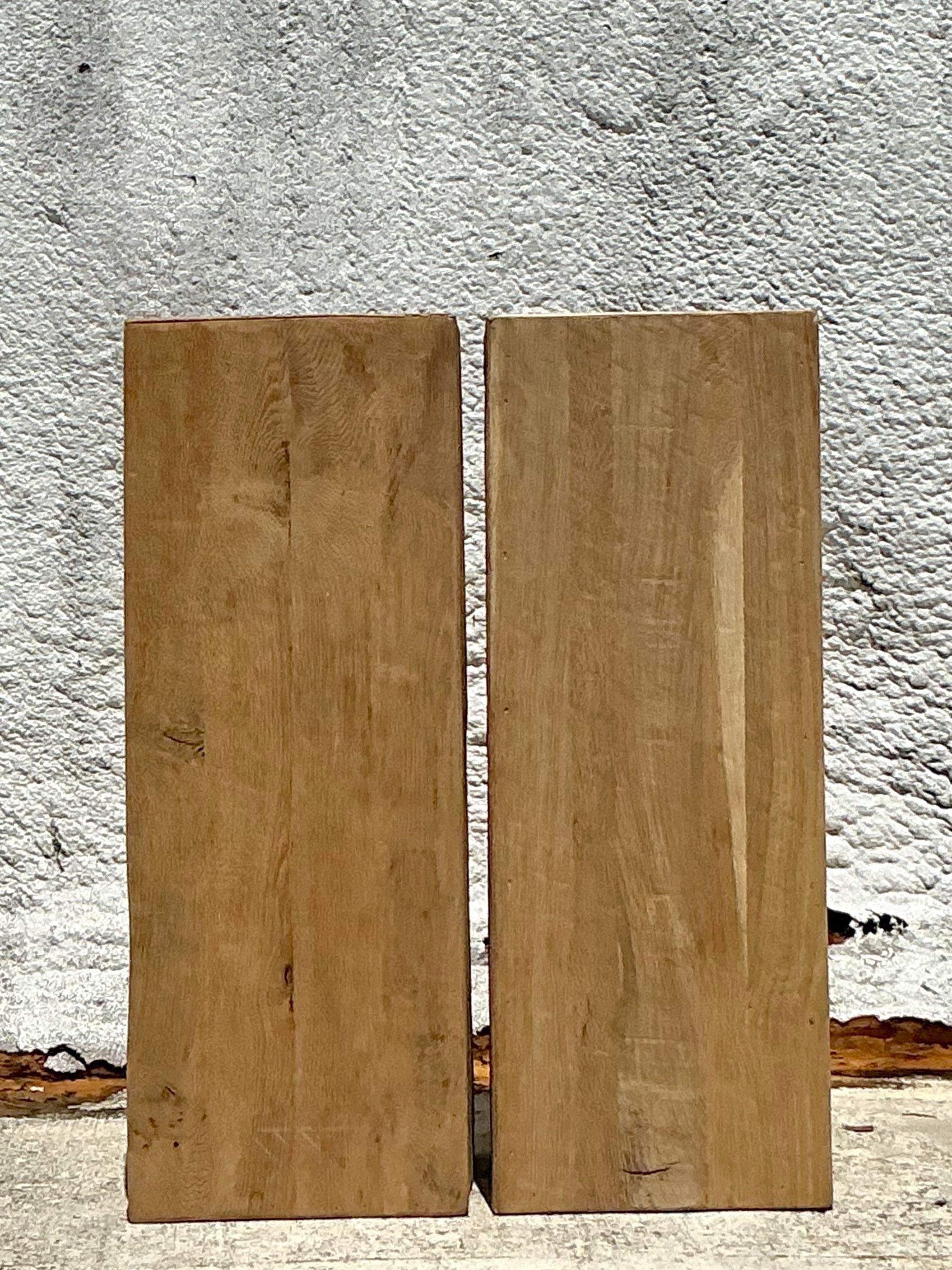 Diese Vintage-Boho-Holzsockel, die als Paar angeboten werden, fangen den eklektischen und natürlichen Charme des amerikanischen Boho-Stils ein. Mit aufwendigen Details und einer warmen Holzoberfläche bieten sie eine perfekte Plattform für die