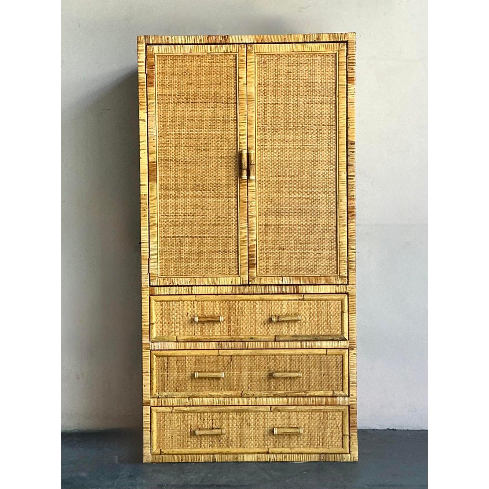 Elevate your living space with this exquisite vintage armoire, masterfully crafted from woven rattan and bamboo, embodying a captivating Boho-chic aesthetic. This piece features a beautifully textured surface with a warm, natural hue, perfect for