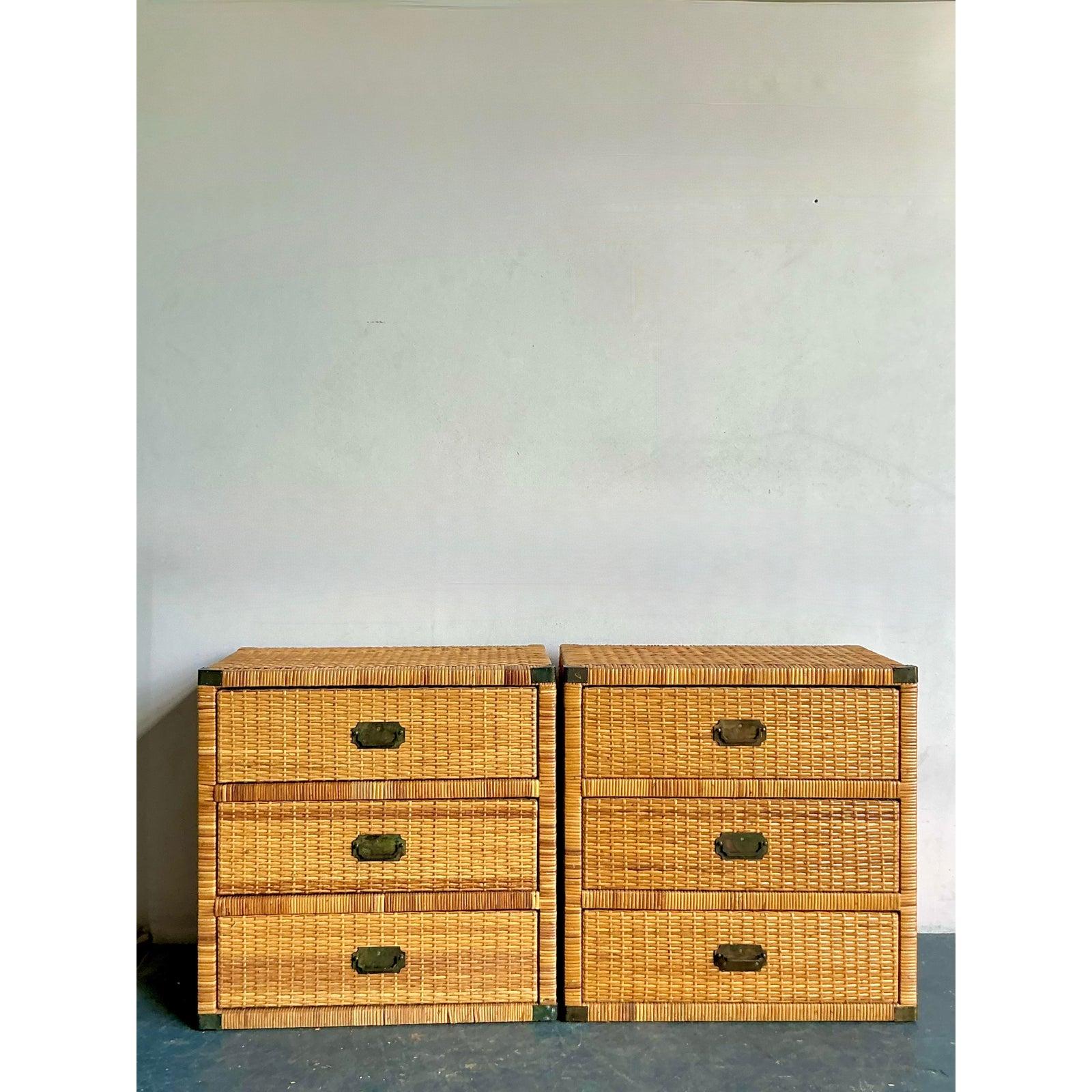 Discover this charming pair of vintage woven rattan campaign chests, perfect for adding a touch of relaxed bohemian elegance to any interior. These chests exude a laid-back yet sophisticated style, characterized by their meticulously woven rattan