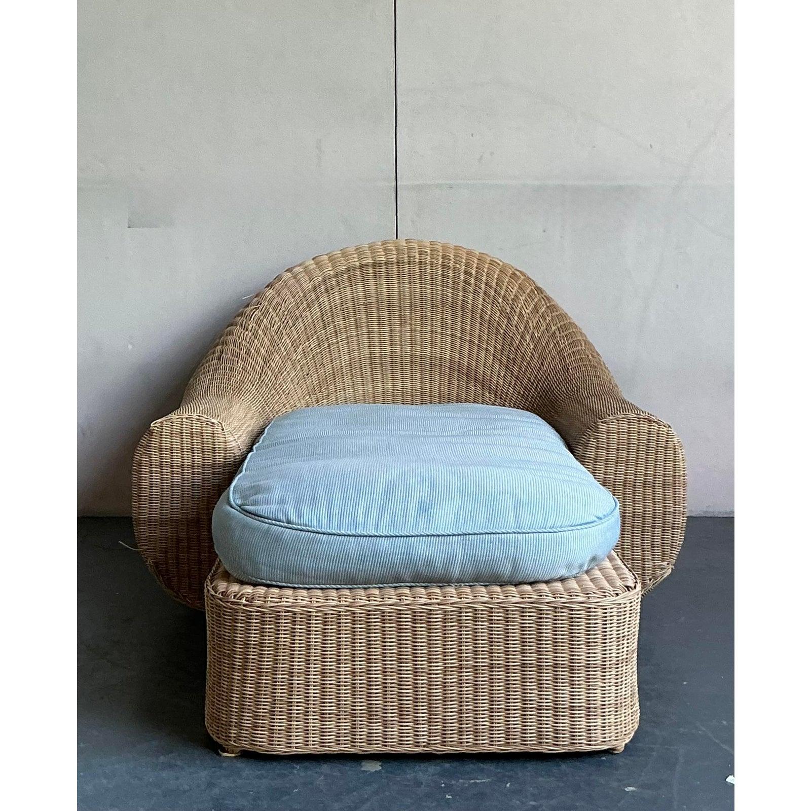 Embrace the monumental scale and organic modernism of Michael Taylor with this extraordinary vintage chaise lounge. Expertly hand-woven from natural rattan, this piece showcases a bold, sculptural silhouette with oversized, rounded arms that create