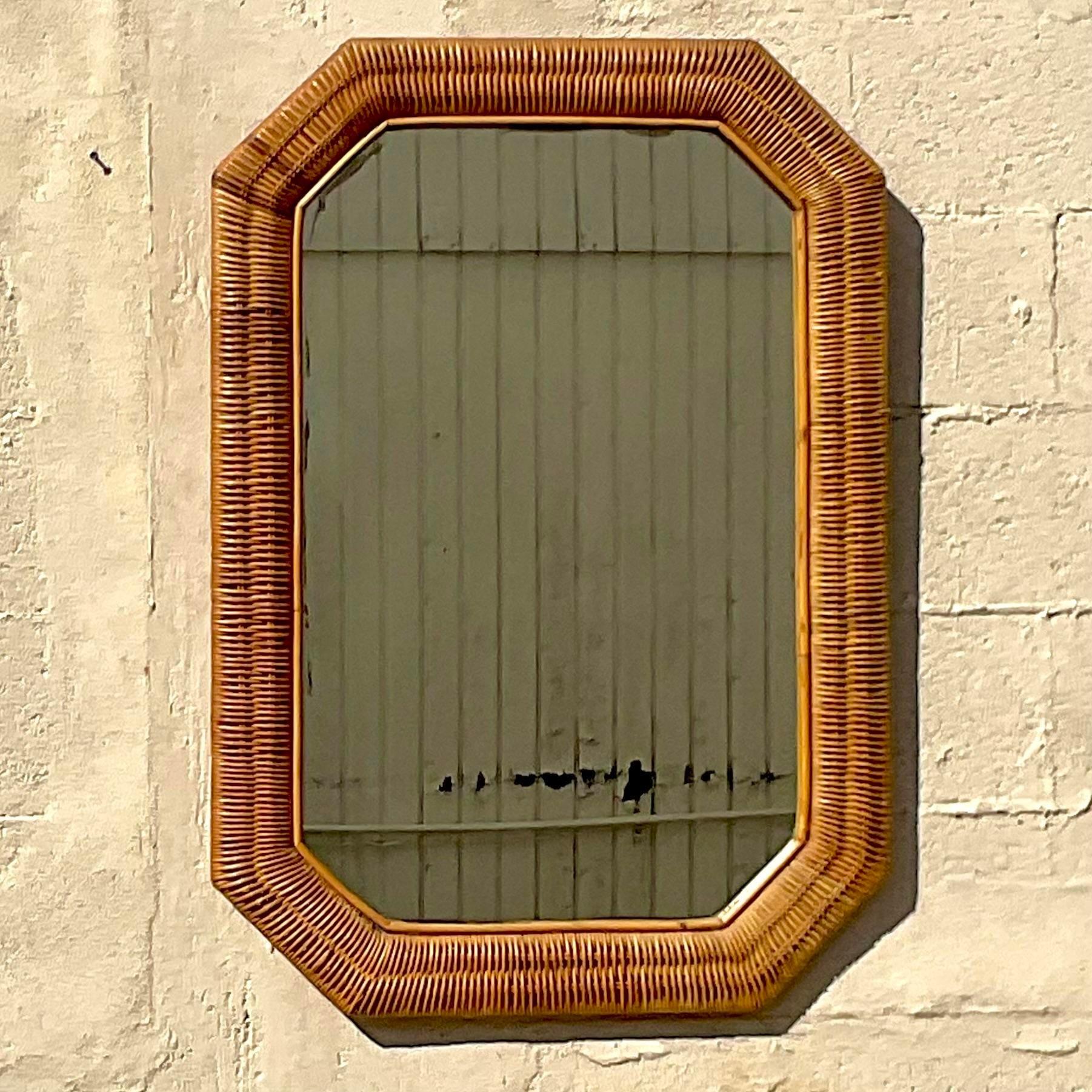 A fantastic vintage Boho mirror. Beautiful woven rattan in a chic octagon shape. Acquired from a Palm Beach estate.