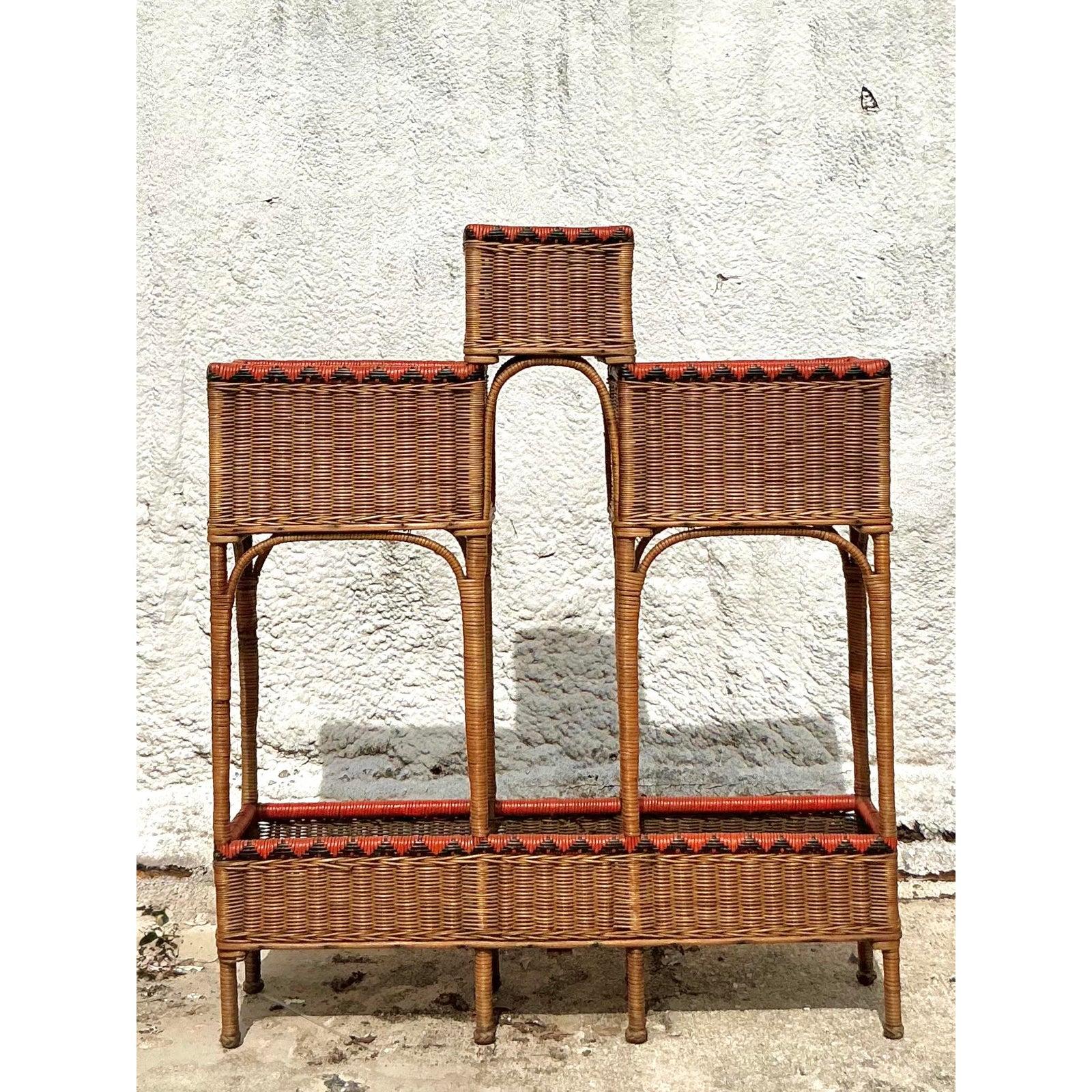 Elevate your indoor garden with this spectacular vintage woven rattan plant stand. A true masterpiece of bohemian design, this piece features a striking, multi-level architectural structure, perfect for creating a dynamic display of cascading