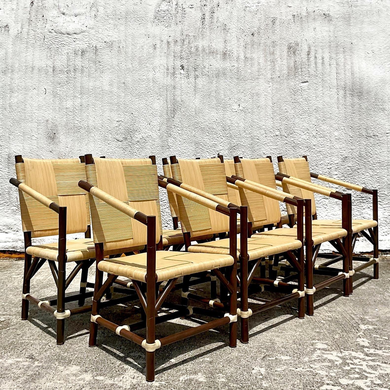 A fabulous vintage Boho set of dining chairs. Done in the manner of a John Hutton for Donghia. Thr set is a stunning collection of 8 arm chairs. Each one exuding the unique and captivating Block Island style. Lacquered rattan and a solid rattan