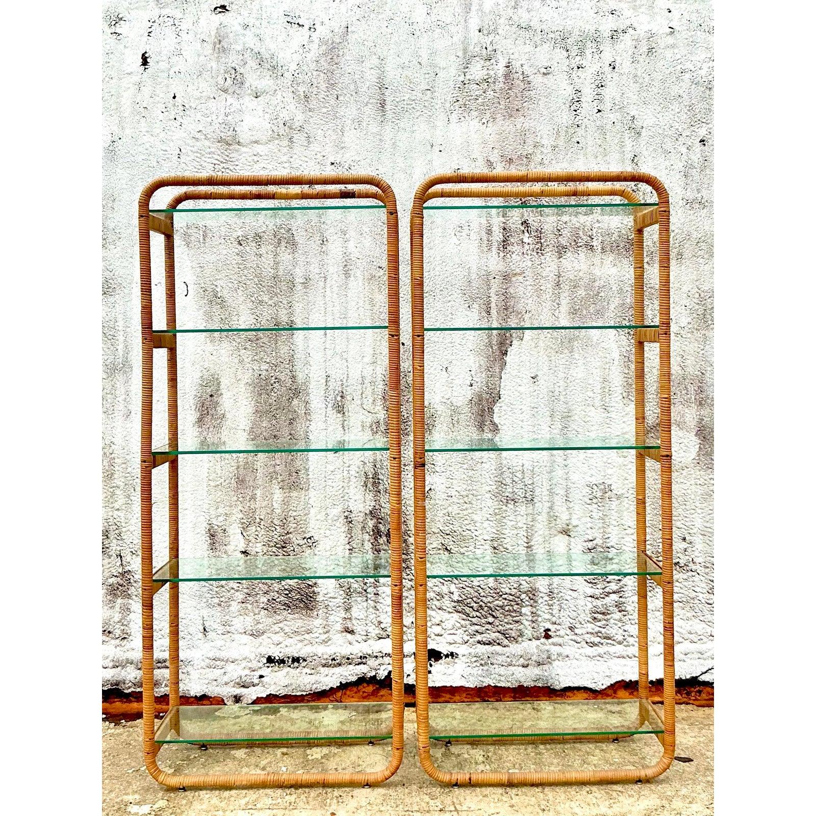 Infuse your interiors with a captivating blend of natural elegance and vintage charm with this exceptional pair of wrapped rattan etageres. Their gracefully arched, continuous loop frames showcase the quintessential appeal of 1970s organic modern