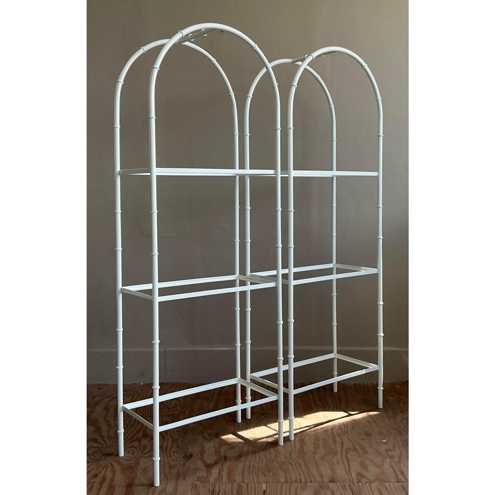 Introduce a touch of timeless Chinoiserie chic into your home with this stunning pair of vintage arched etageres. The graceful, pagoda-like arch and elegant faux bamboo detailing evoke the glamorous aesthetic of Hollywood Regency design. Crafted