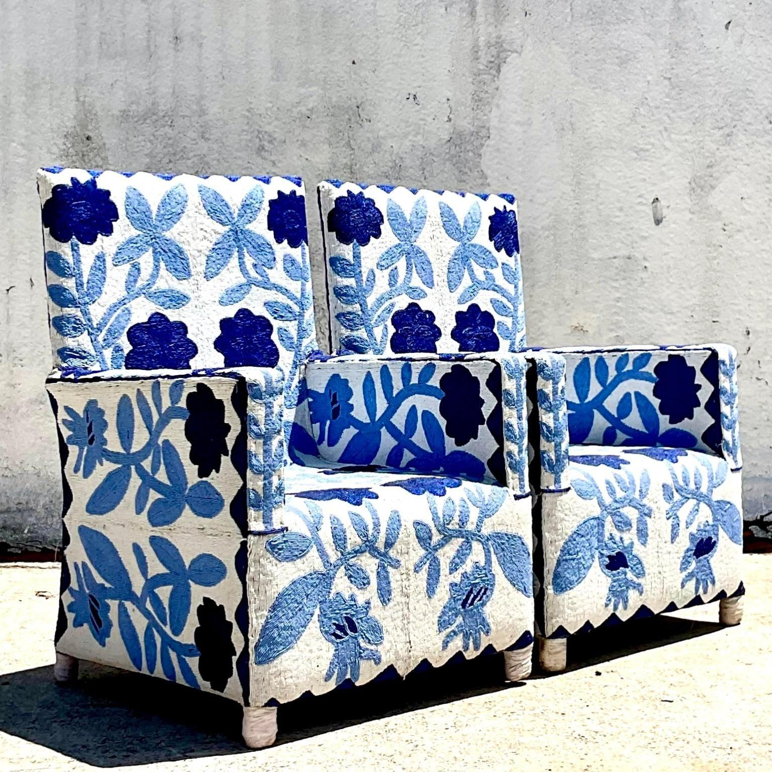 An extraordinary pair of vintage lounge chairs. The Yoruba chair hand beaded in Nigeria. Brilliant blue and white floral design. Acquired from a Palm Beach estate.