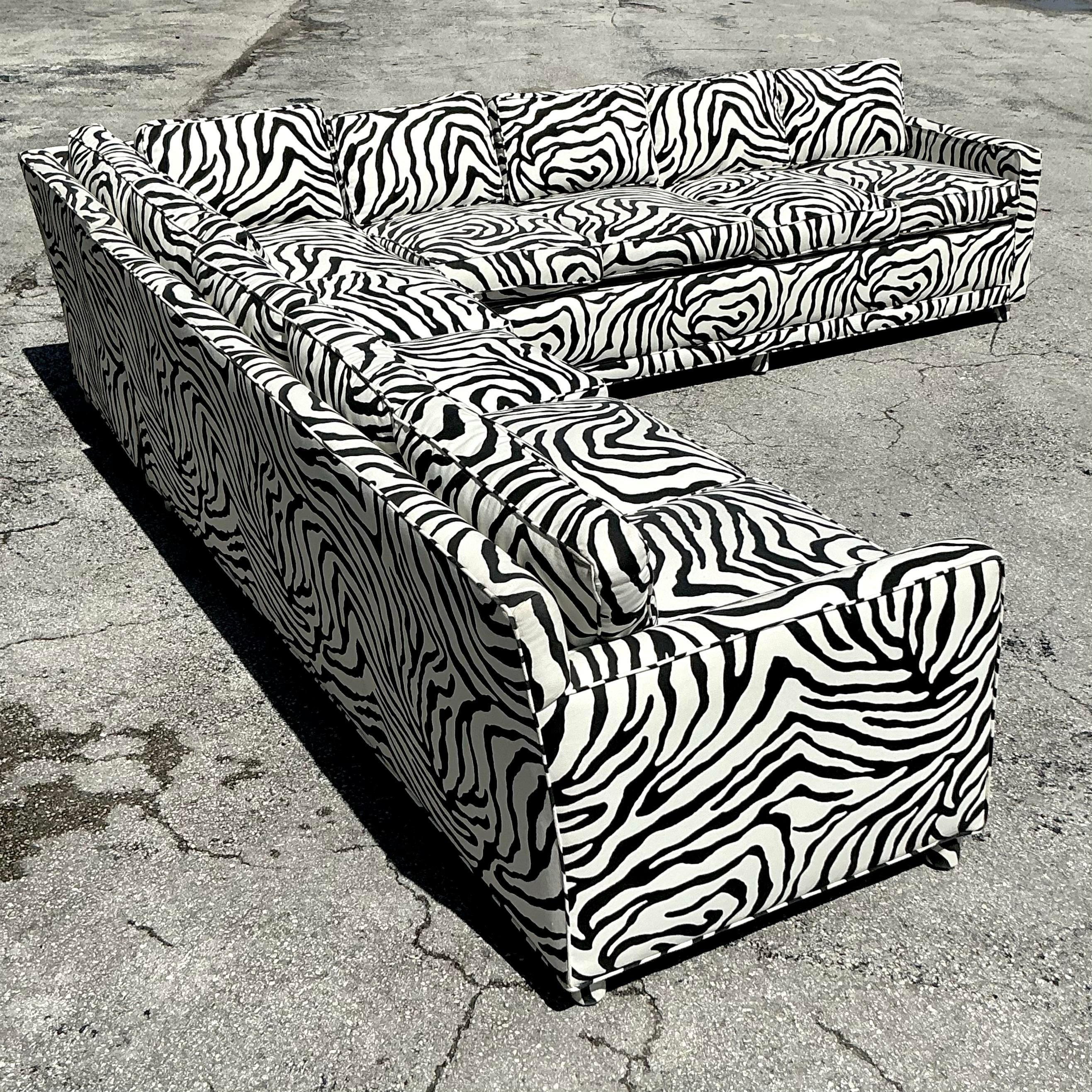 Make a bold statement in your living space with this Vintage Boho Zebra Stripe Parsons Sectional Sofa. Featuring a striking black-and-white zebra stripe upholstery, this sectional embodies bohemian flair with a touch of retro glamour. The