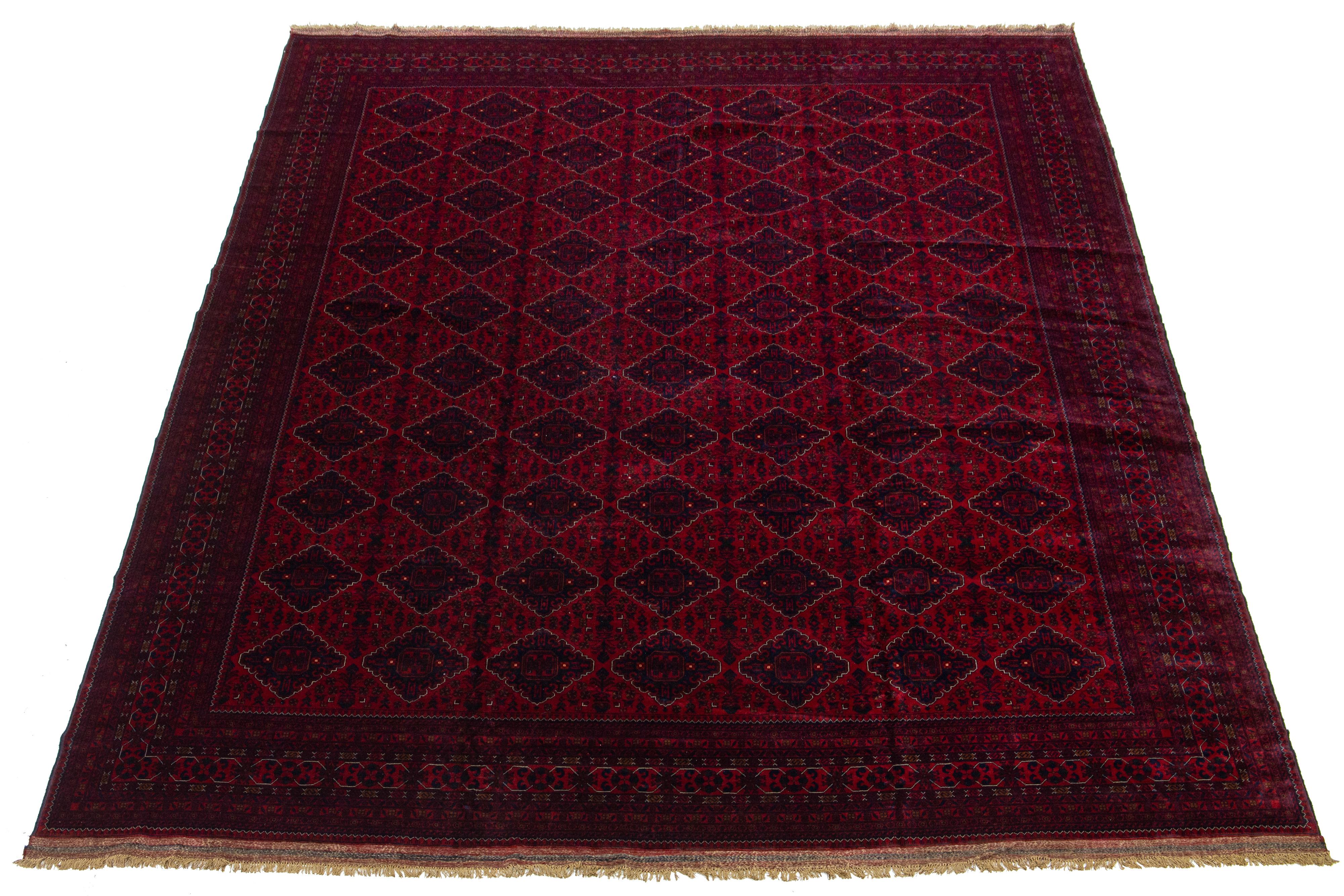 Beautiful vintage Bokhara hand-knotted wool rug with a red field. This Persian rug has navy blue accents in a gorgeous all-over geometric Pattern Design.

This rug measures 13'1