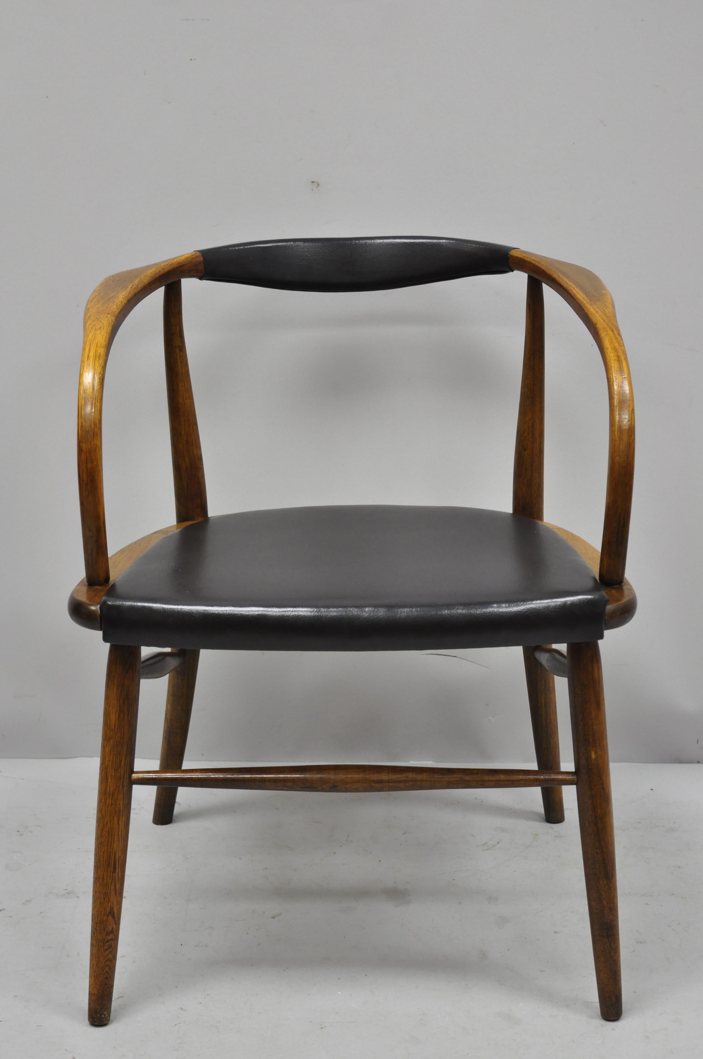 Vintage Mid-Century Modern oak barrel back Danish modern chair after Hans Wegner. Item features vinyl wrapped back and seat, solid wood frame, beautiful wood grain, clean modernist lines, sleek sculptural form, circa 1960. Measurements: 26.5